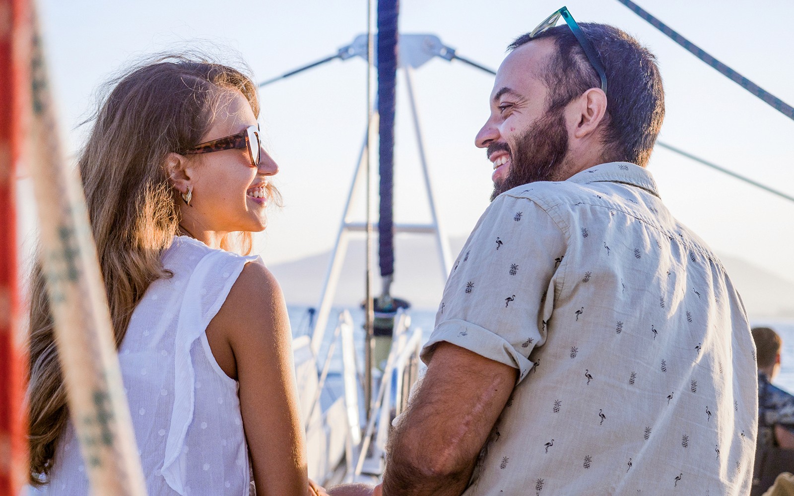 Couple enjoying sunset on a catamaran in Valencia.
