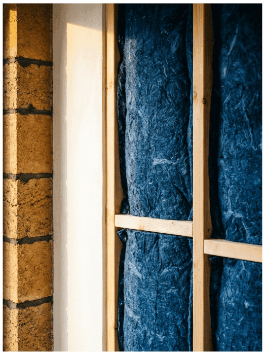 Denim insulation shown inside the Respirabuilt hemp block home.