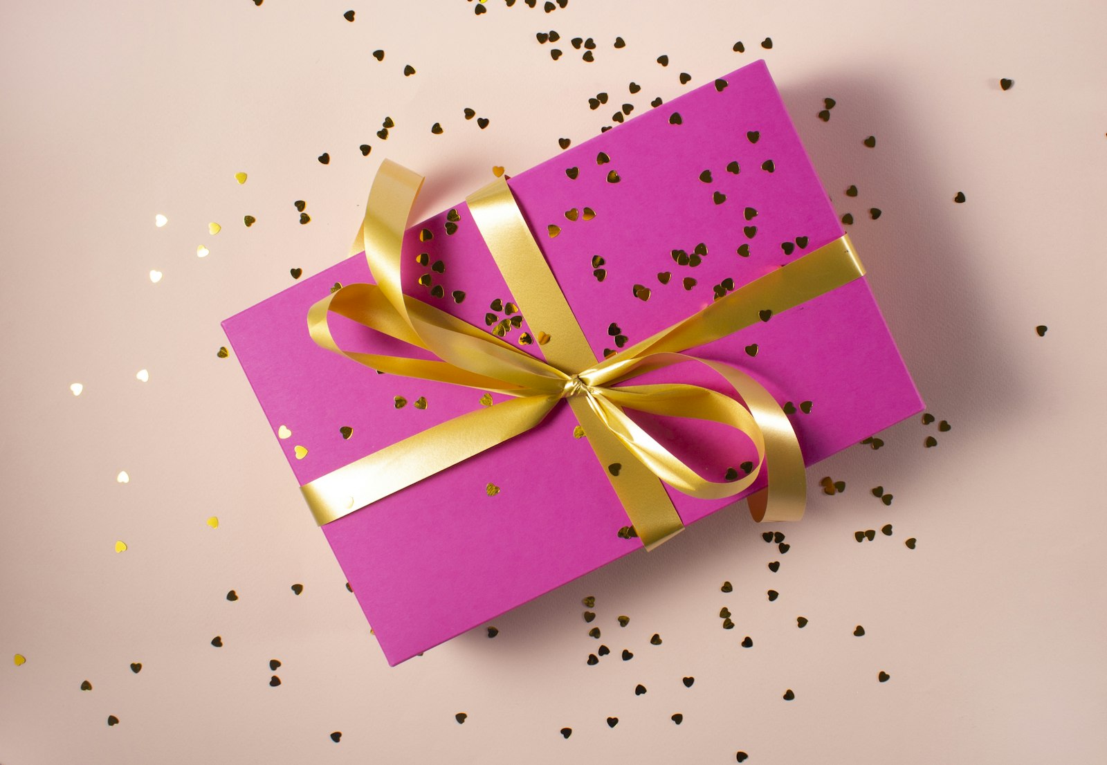 A wrapped gift with a gold ribbon — the whole point of a wishlist