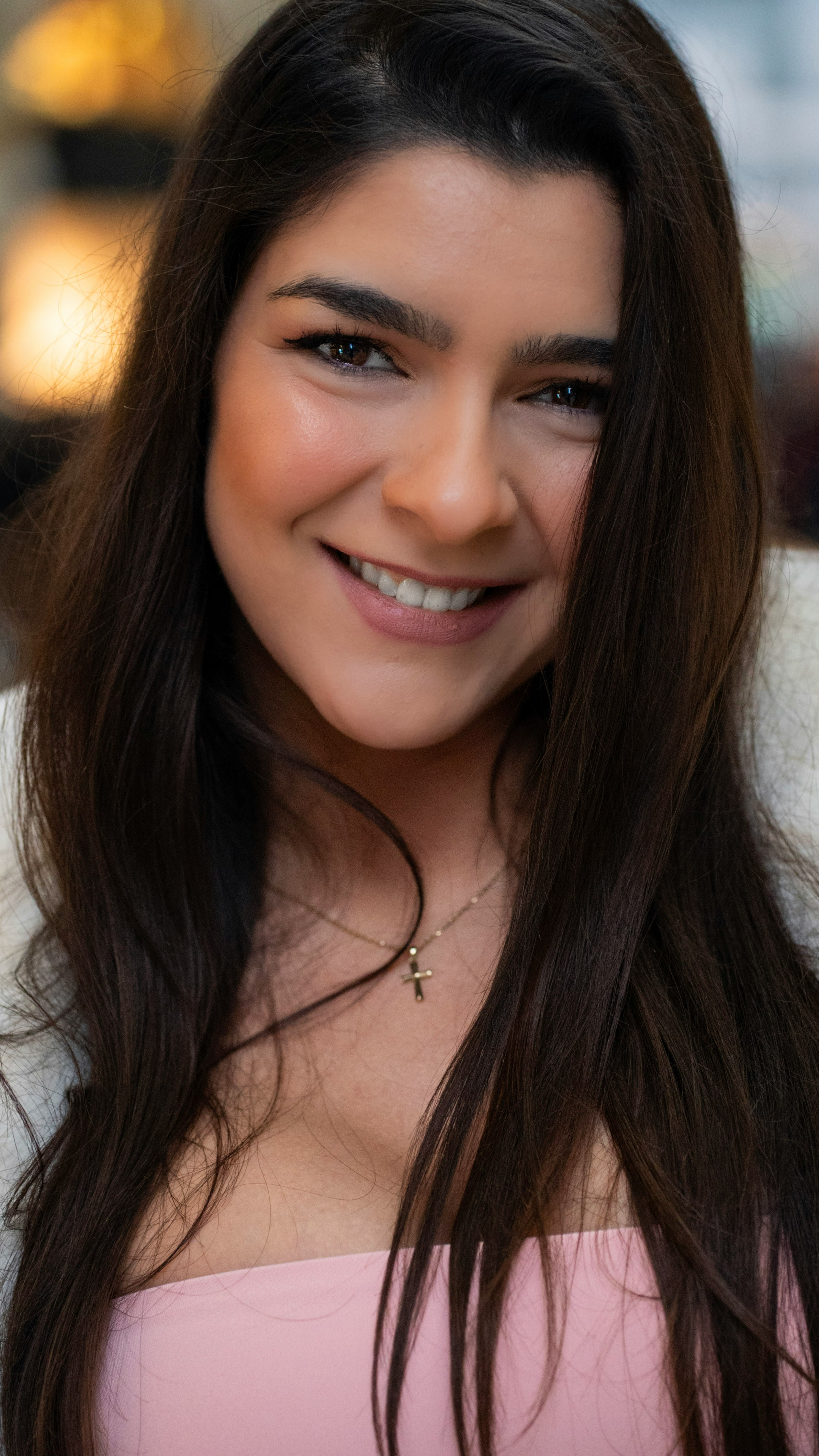 A beautiful woman smiles at the camera.