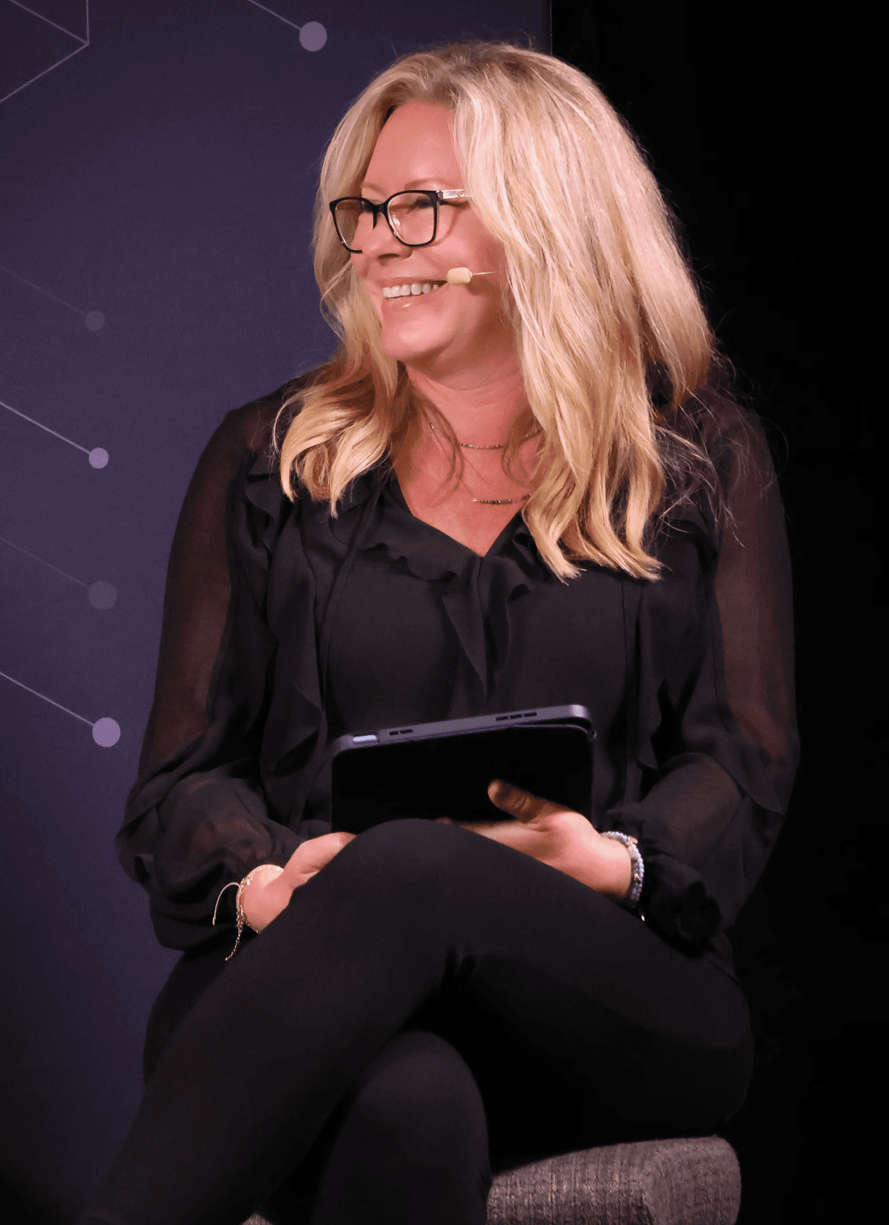 Man smiling while on a video call, sitting at a desk with a laptop and coffee mug.