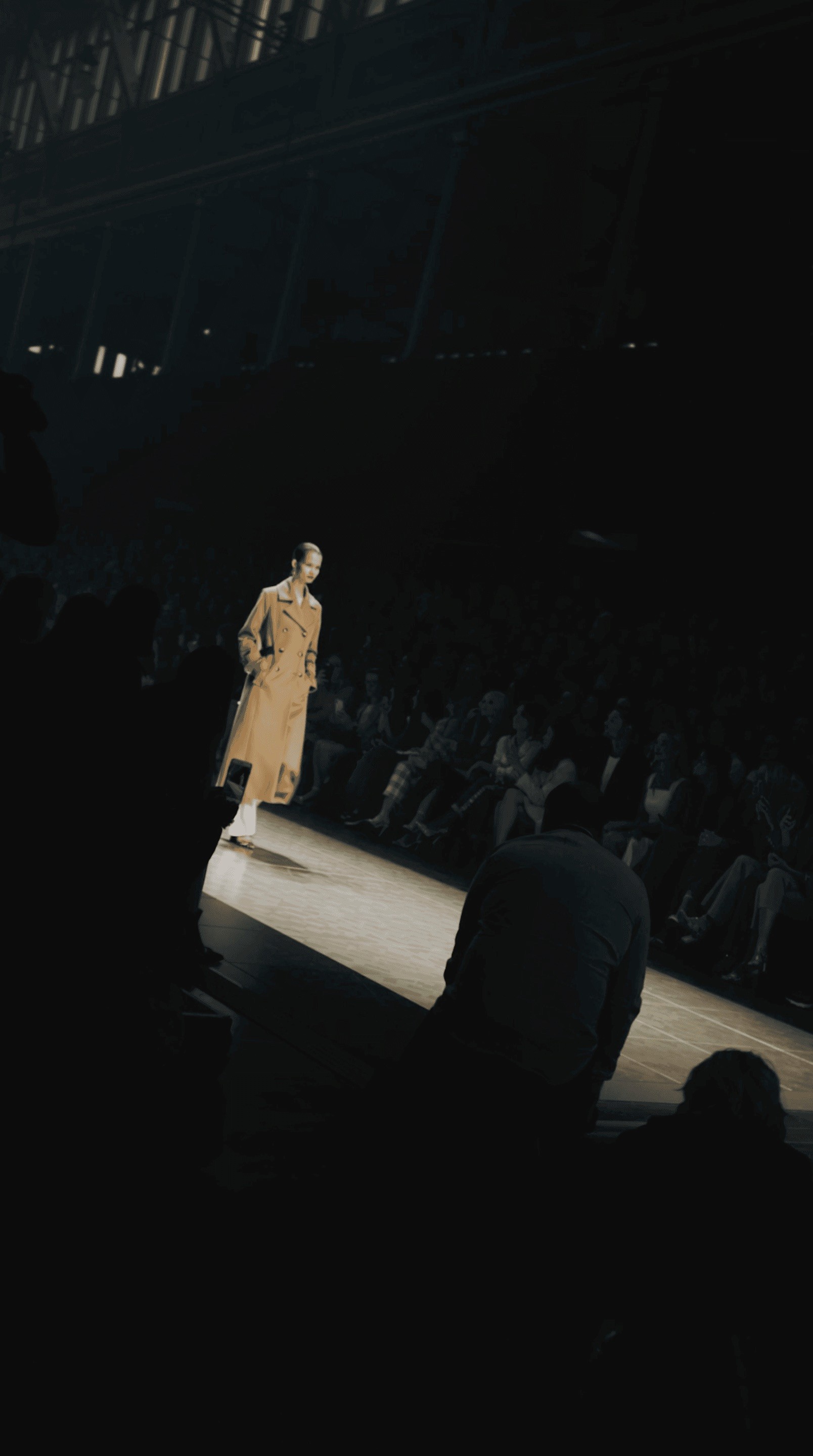 Close-up of a hand holding a lit match against a dark background
