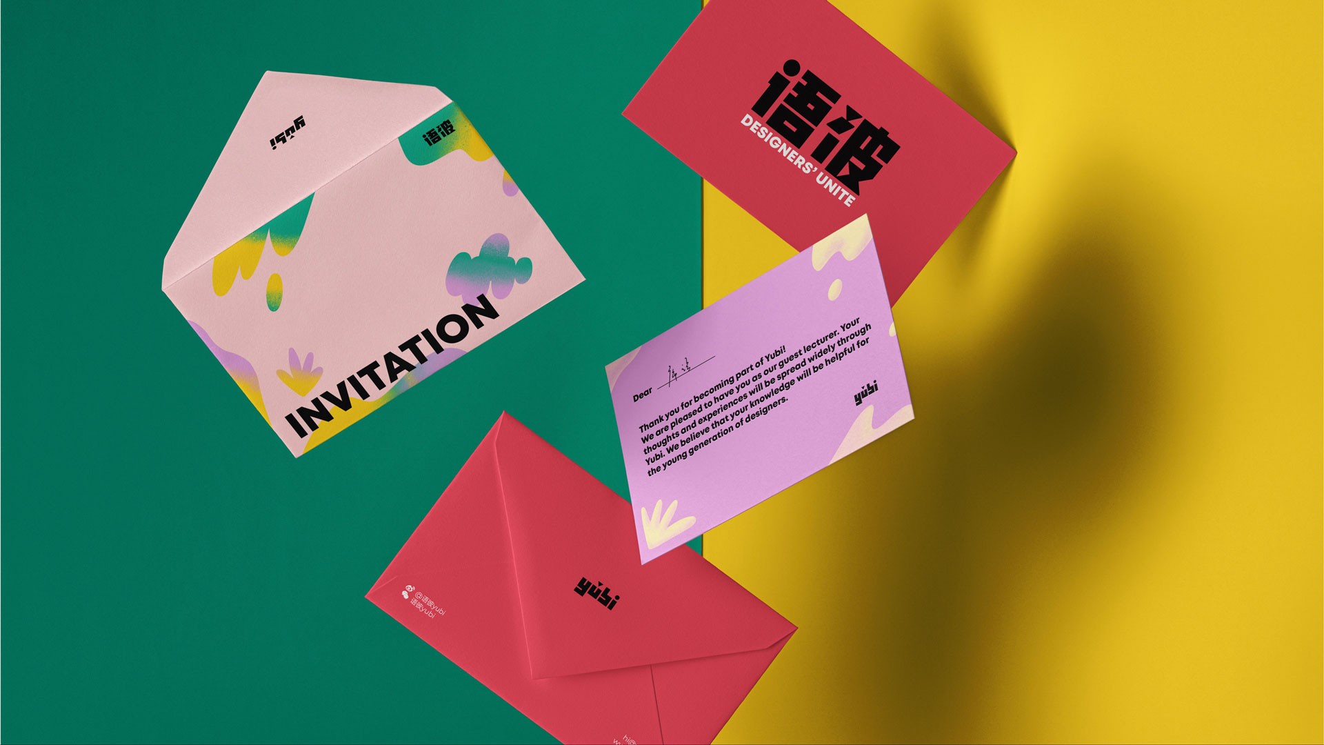 The image shows an open invitation card with a pink background and colorful abstract shapes. The word "INVITATION" is printed in black text on the front flap. Next to it is a light purple card with black text that includes phrases like "Thank You for coming" and "We appreciate your support." A red card with "DESIGNERS' UNITE" in black text is positioned above. A red envelope with a black logo is partially visible at the bottom left. The background is split diagonally into green on the left and yellow on the right.