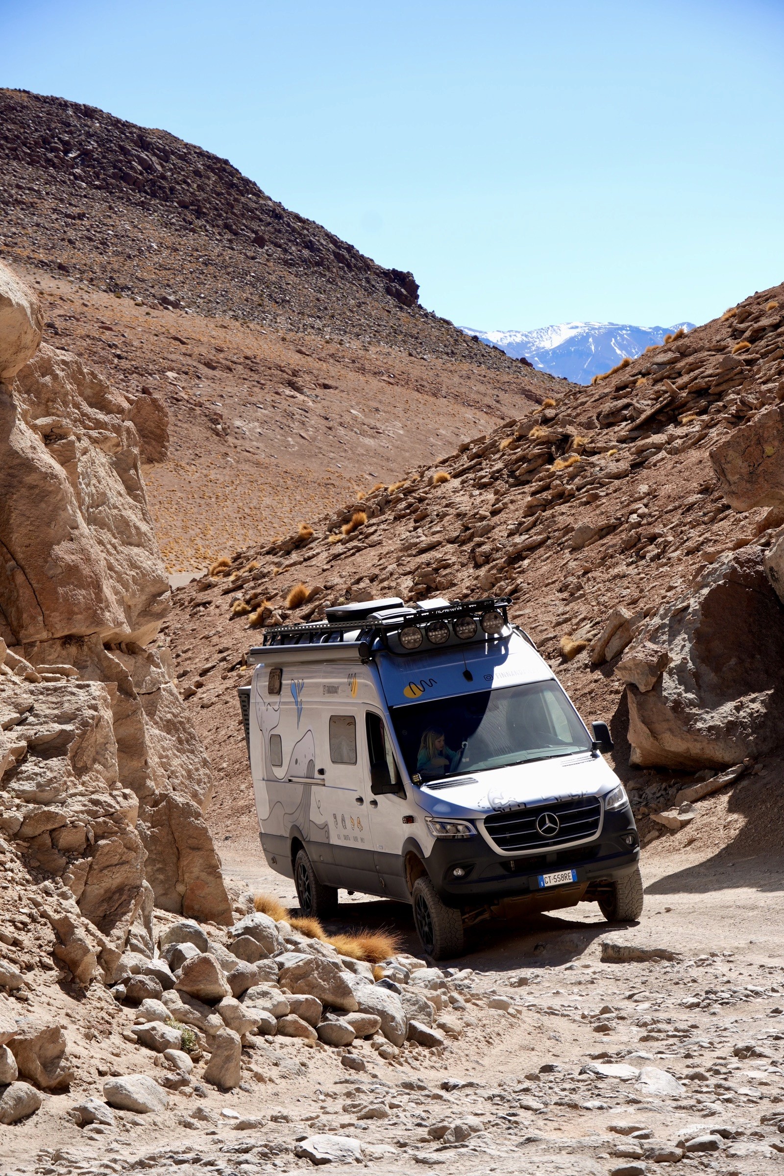 Finn driving through a rocky mountain pass