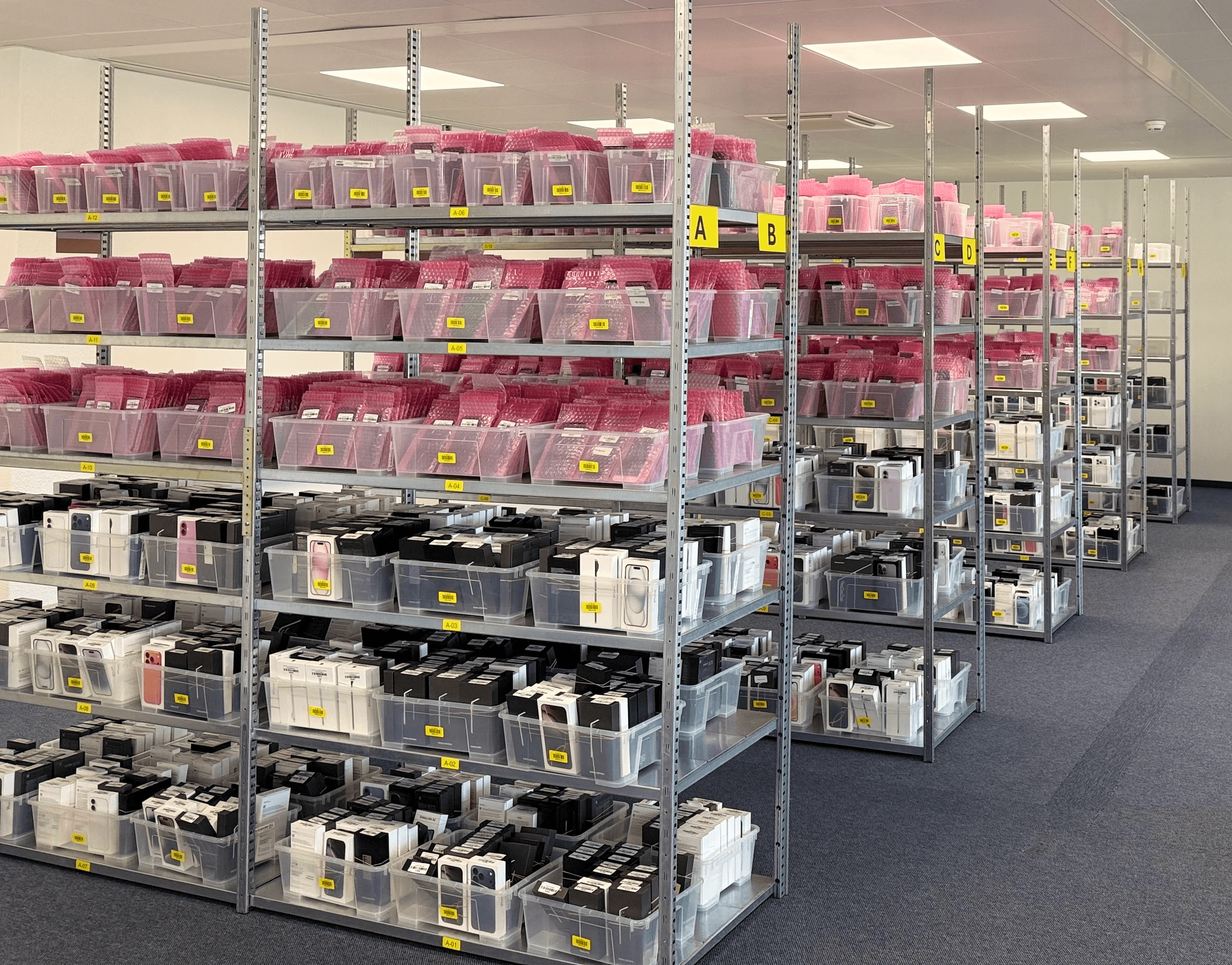 A picture of people working at Recommerce Group. There are two people, a man and a woman, working at their desk in the Recommerce Group open space.