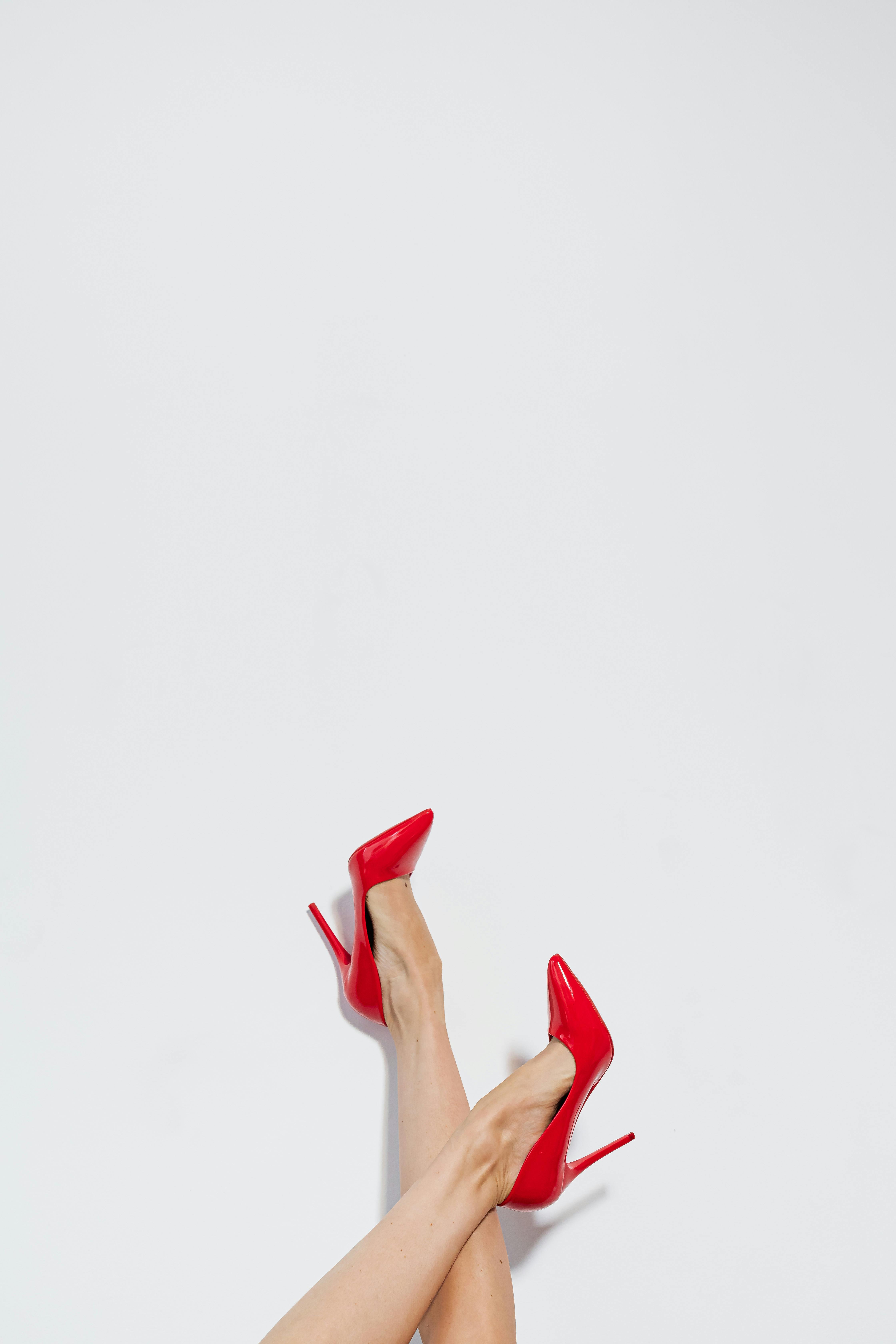 woman's legs with red high heel shoes