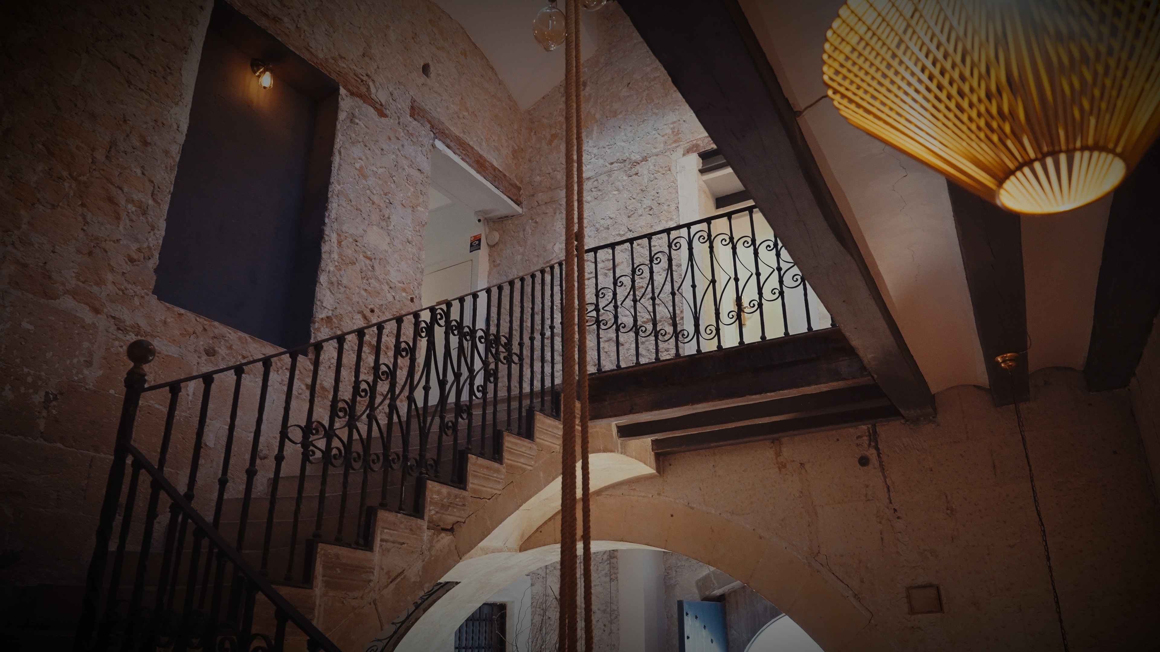 Two men wearing yellow and black face masks, standing side by side, with neutral expressions on their faces.