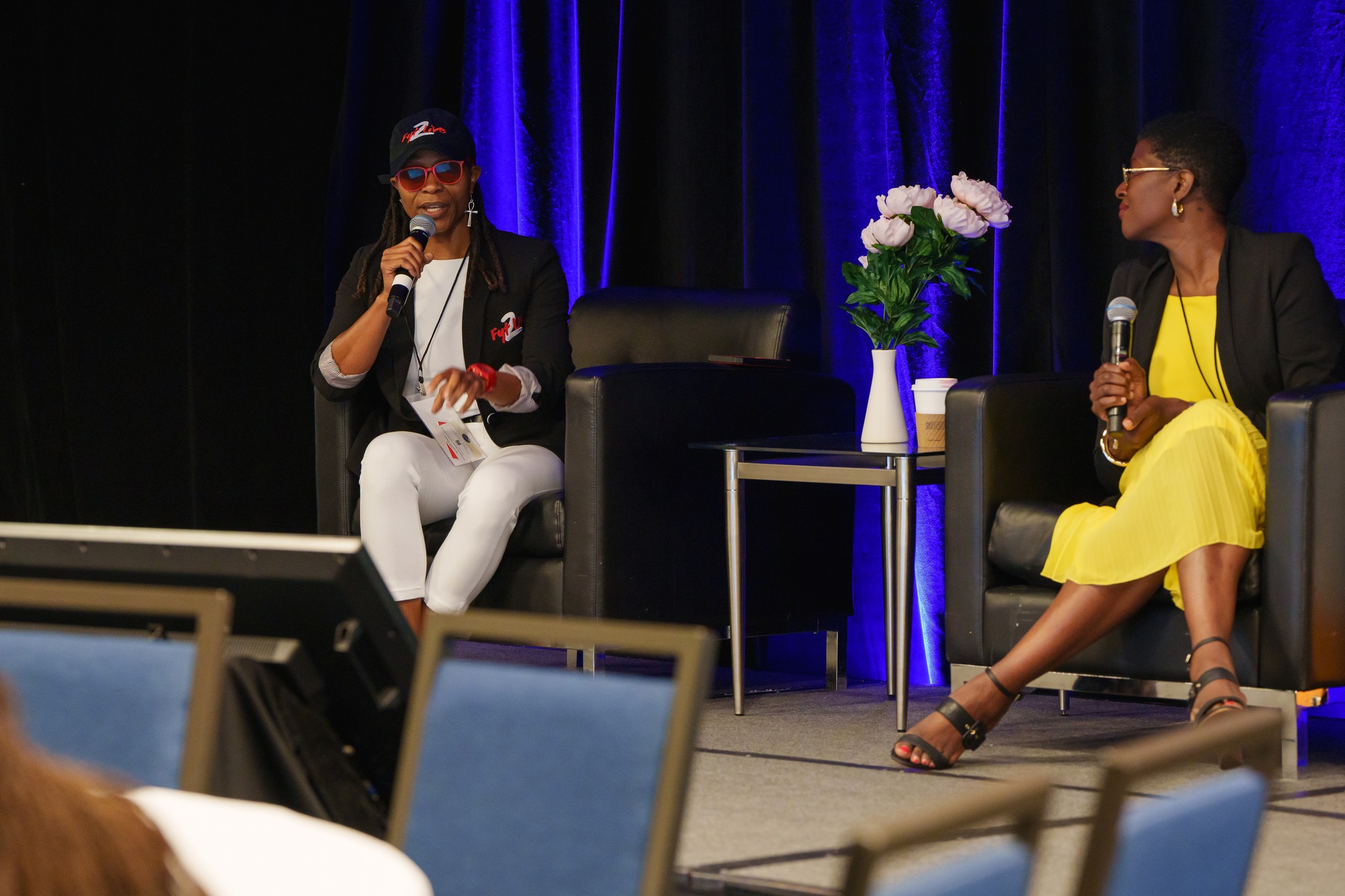 woman sitting around table holding tablet
