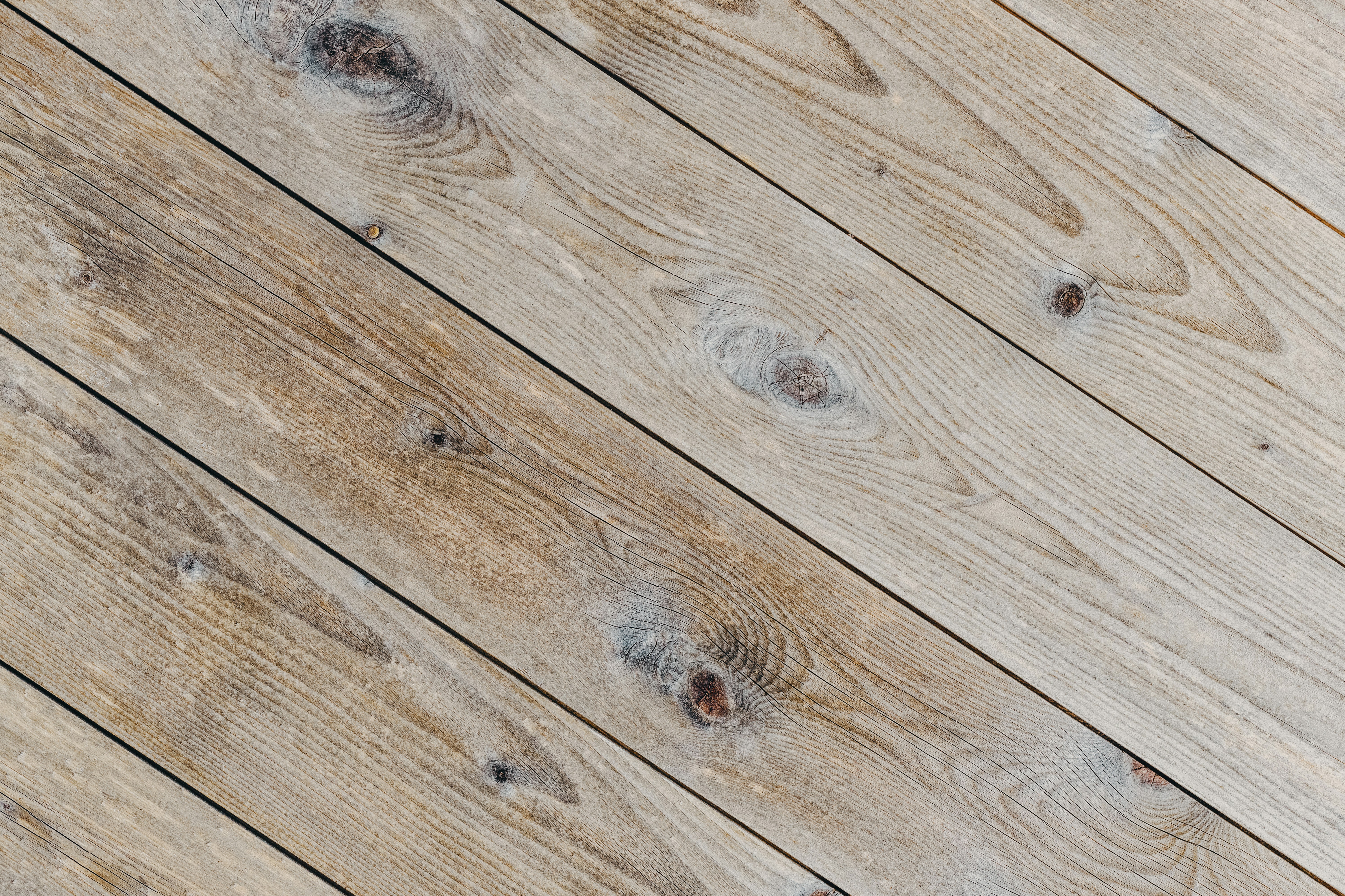 woman in gray shirt sitting on brown wooden floor