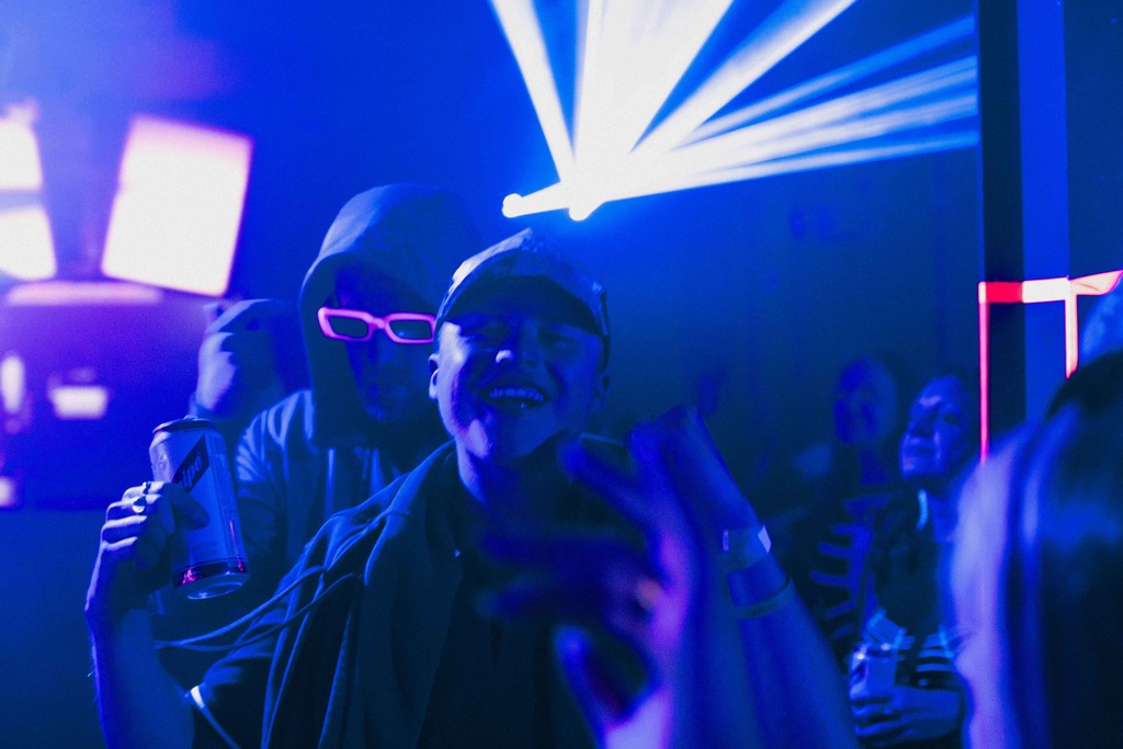 Image of two people enjoying themselves with a laser in the background.