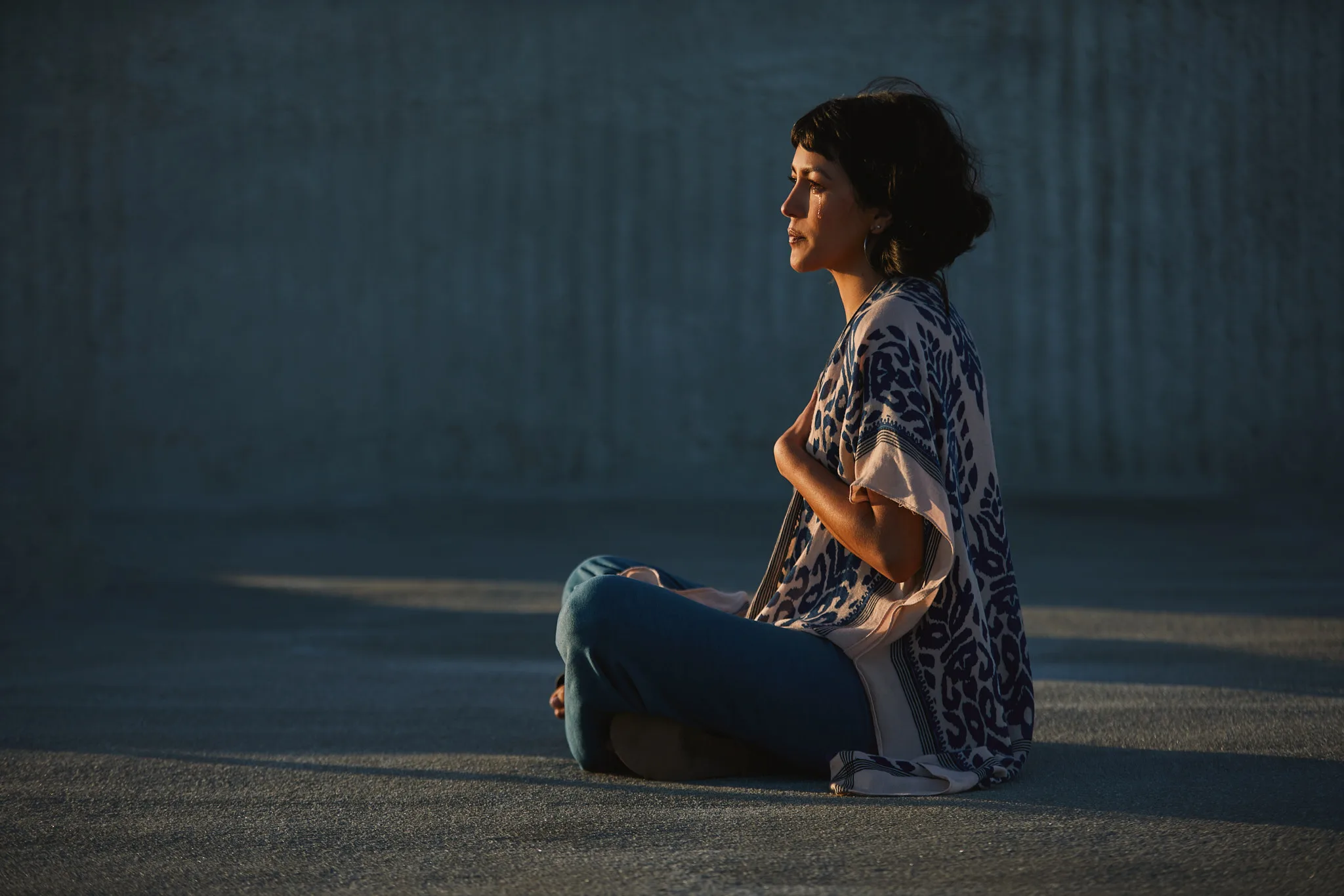 woman sitting cross legged in late light — portrait photography by Tom Kubik