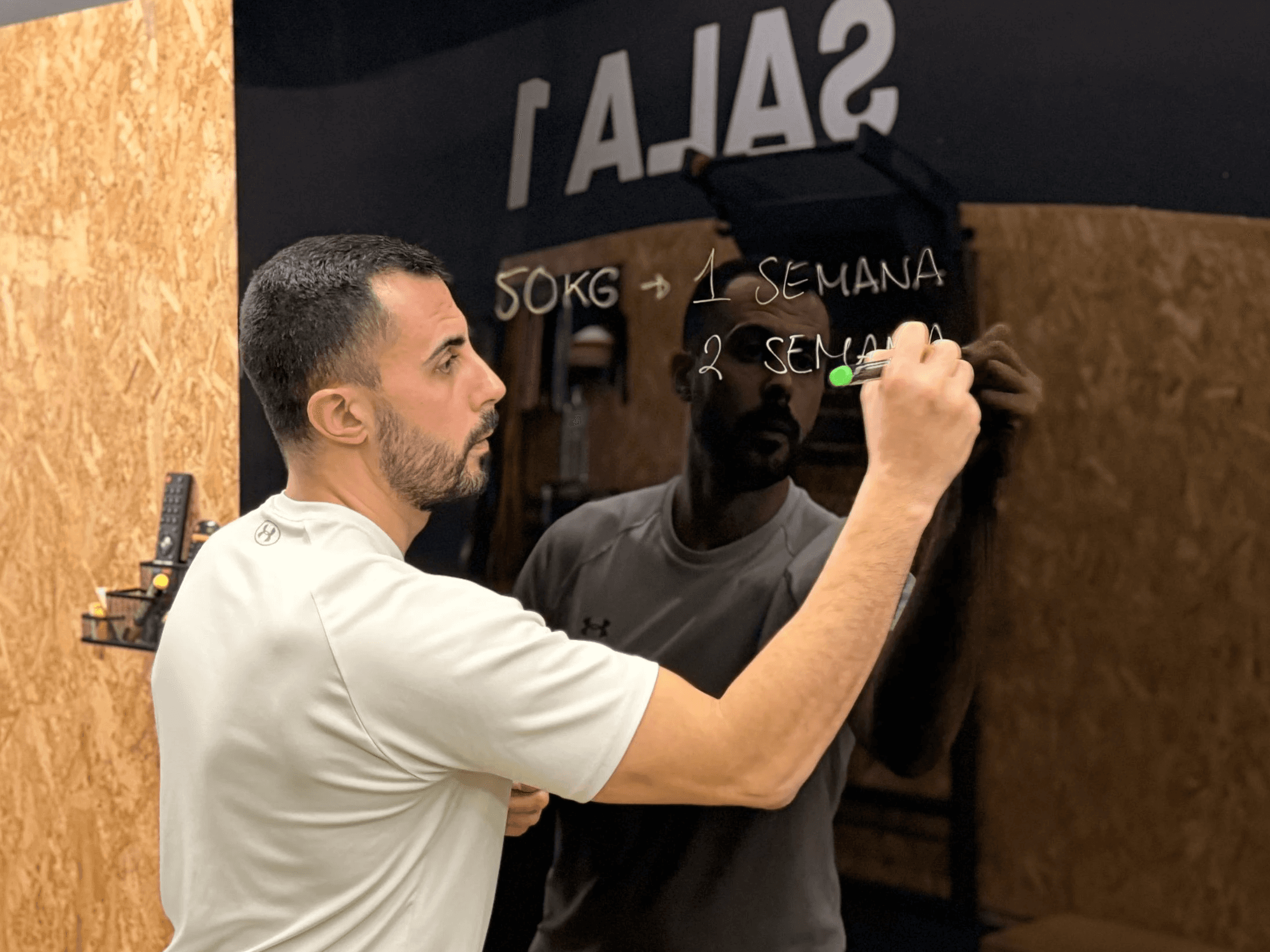 man in black shorts and black tank top doing push up