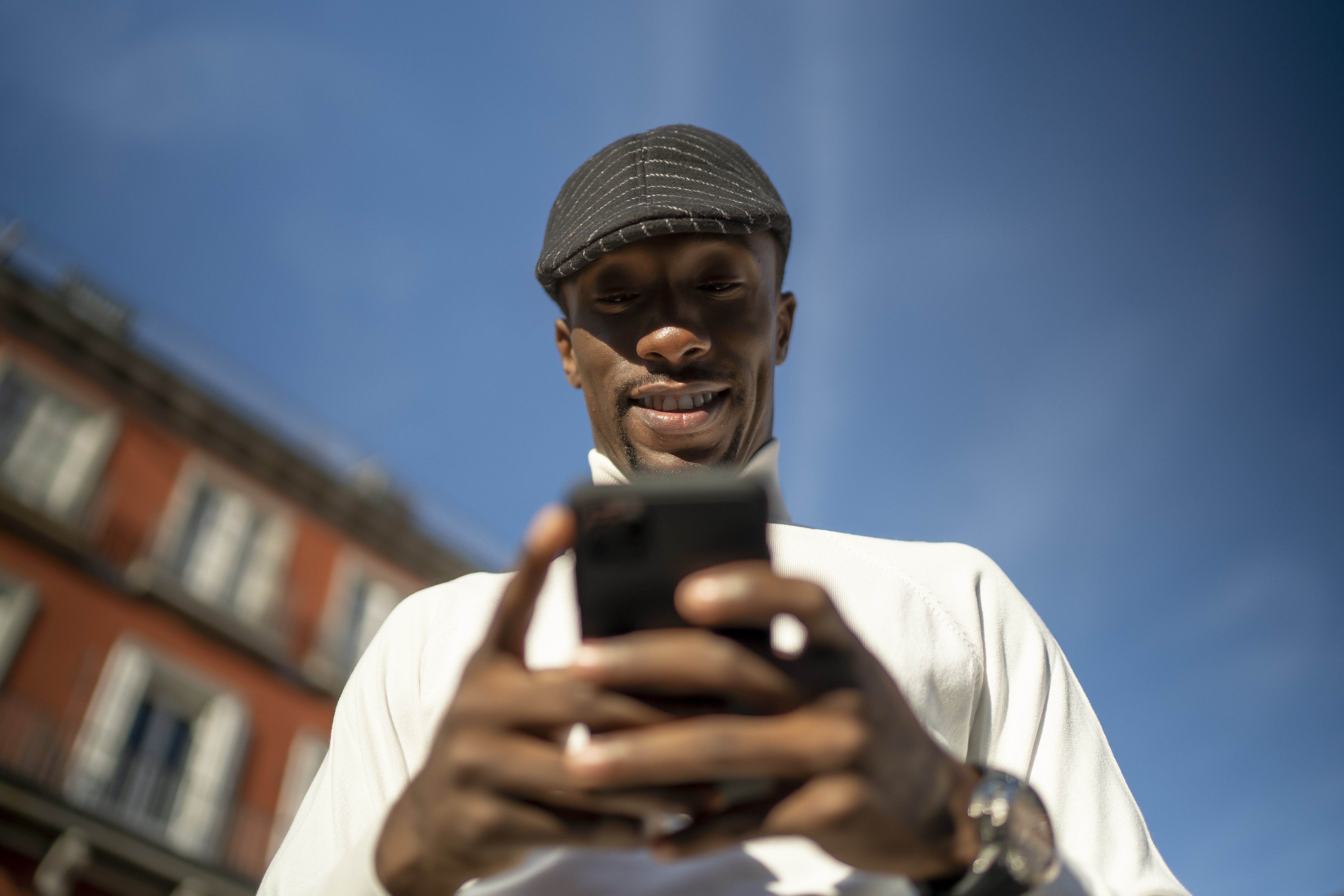 woman holding a phone and man looking at the phone. both are smiling