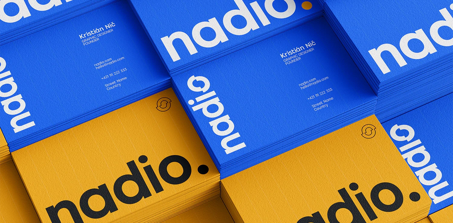 Tote bag with blue handles and yellow designs, featuring the word "radio" on a metal fence.