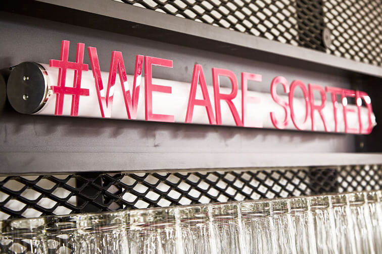 Neon sign reading #WE ARE SORTED