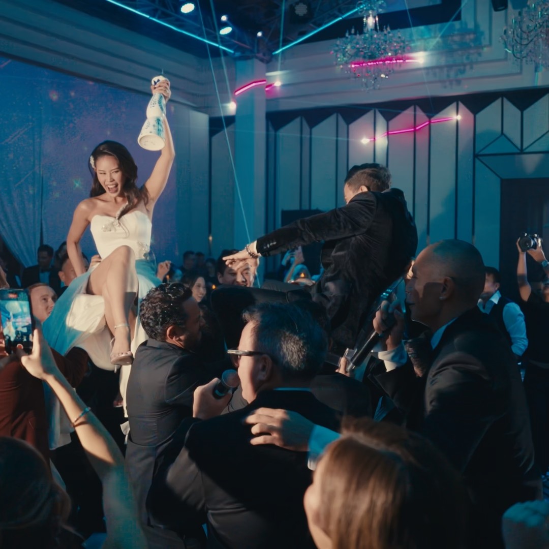 White branded cap with turquoise logo placed on fresh lemons in a red bowl