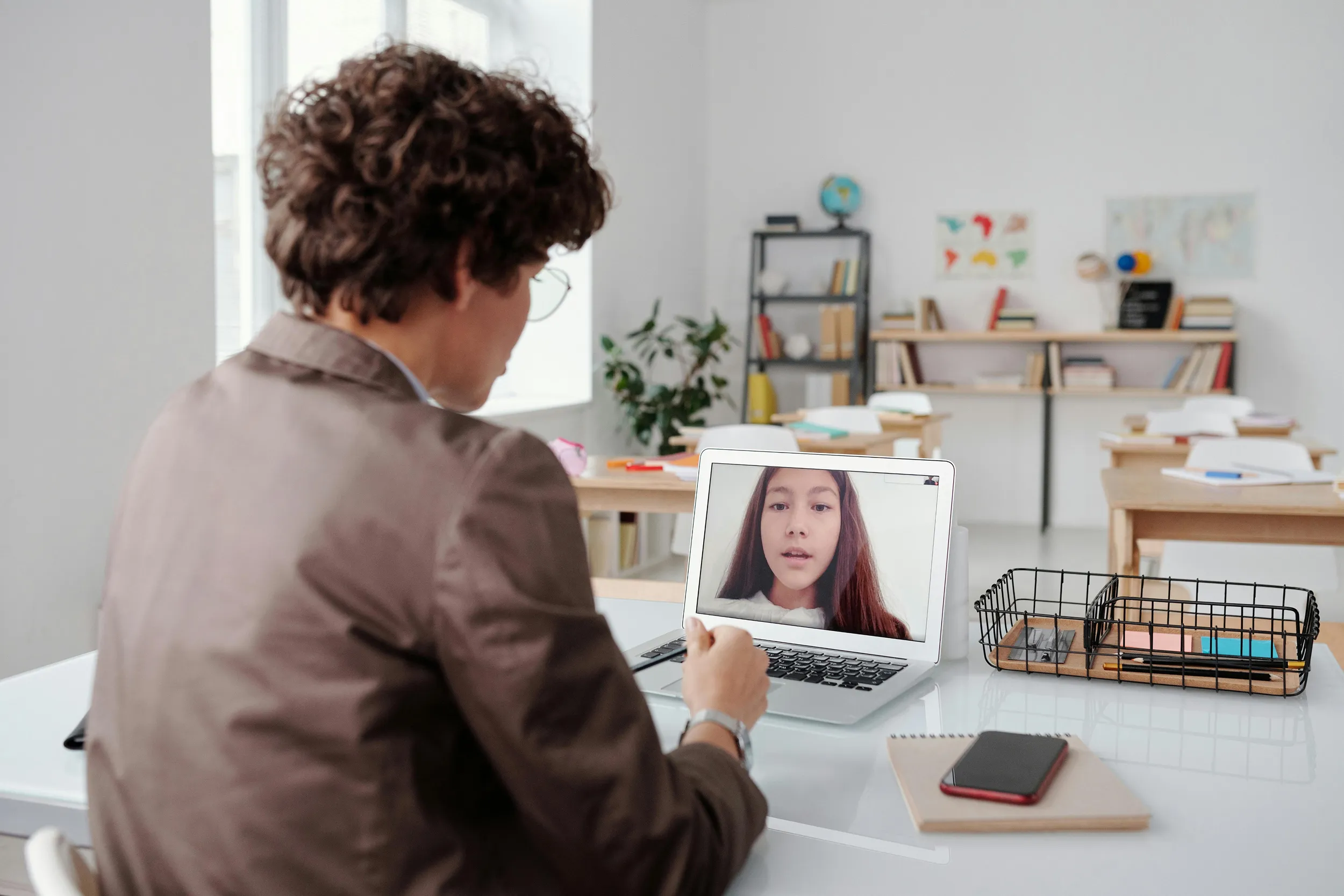 Remote professional having a video call at home workspace, modern online meeting setup