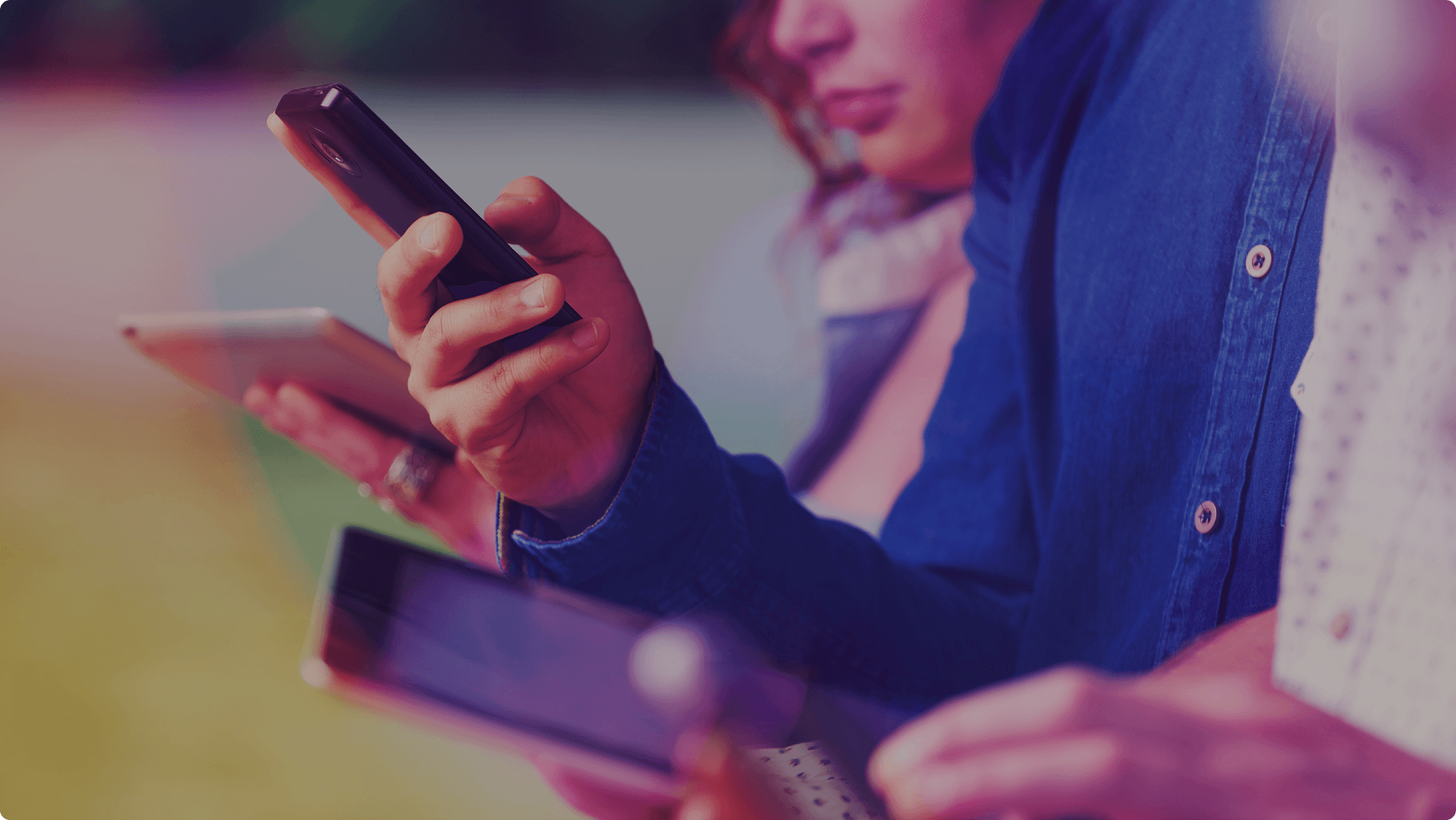 Close up of a group of people looking at their devices