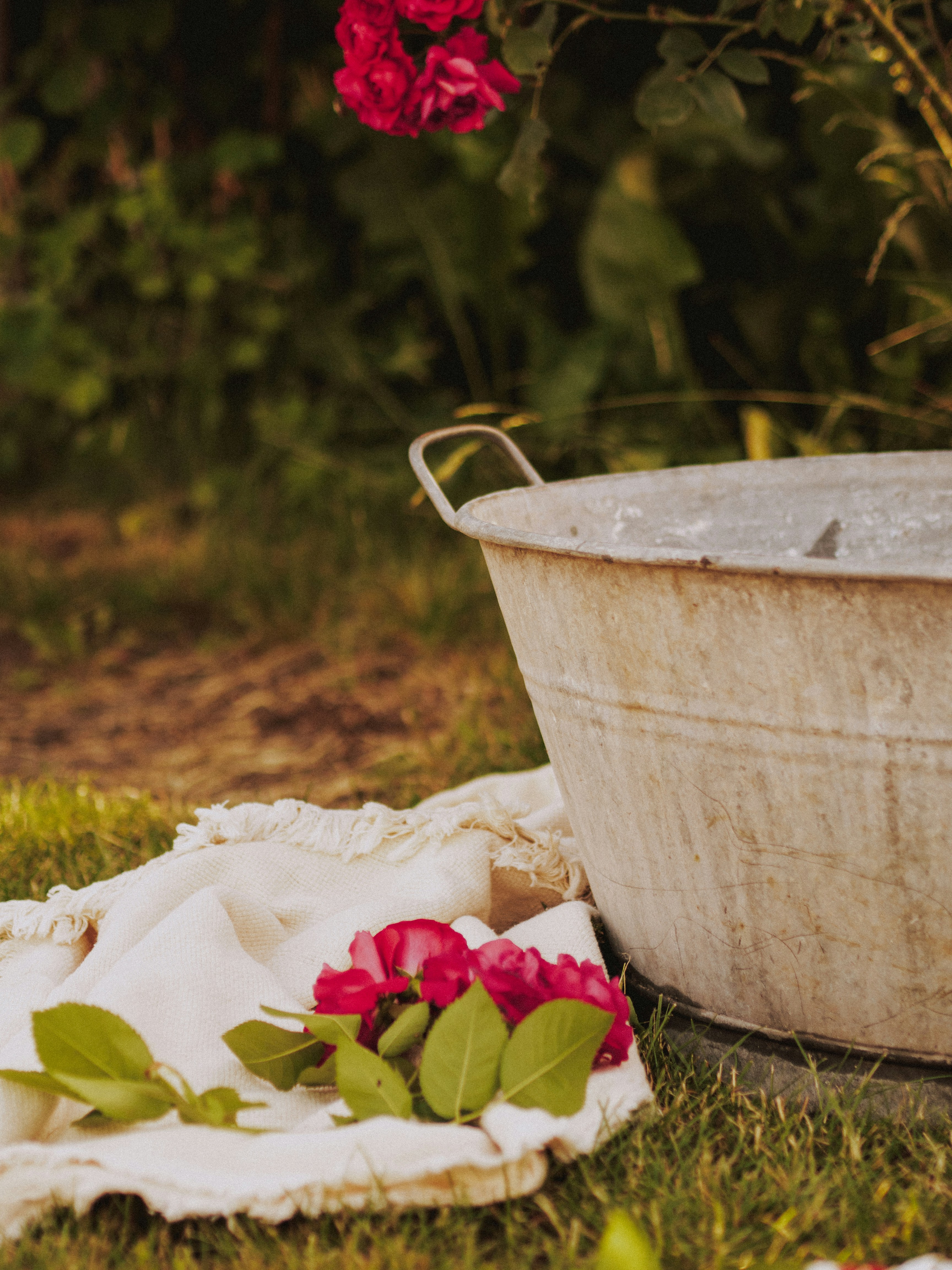 a white bucket with flowers in it