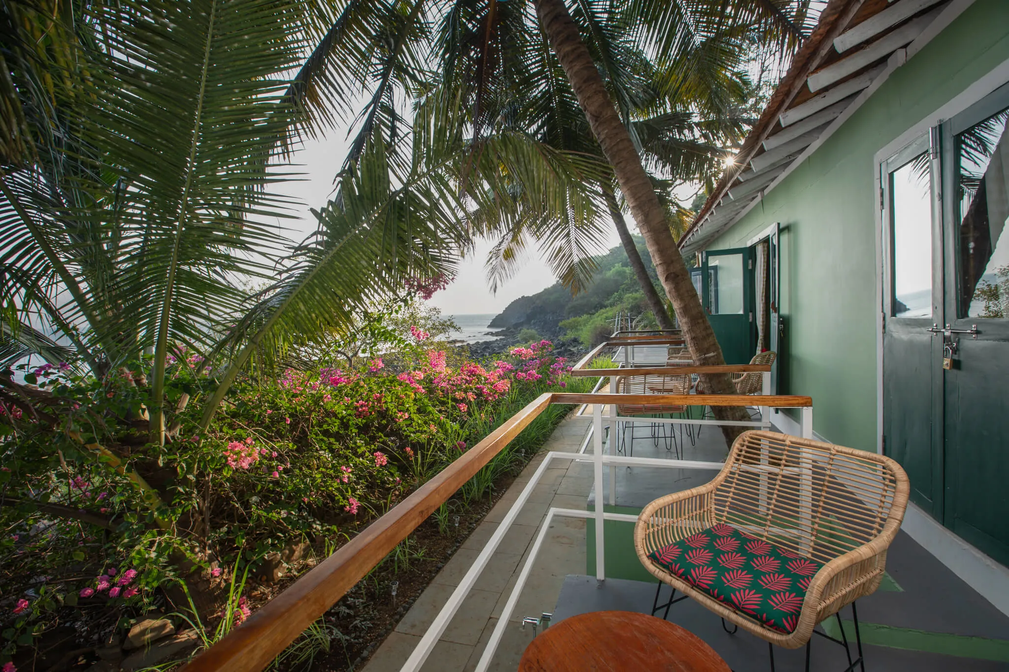 Flower-lined balcony walk above the bay at Casa Jaali
