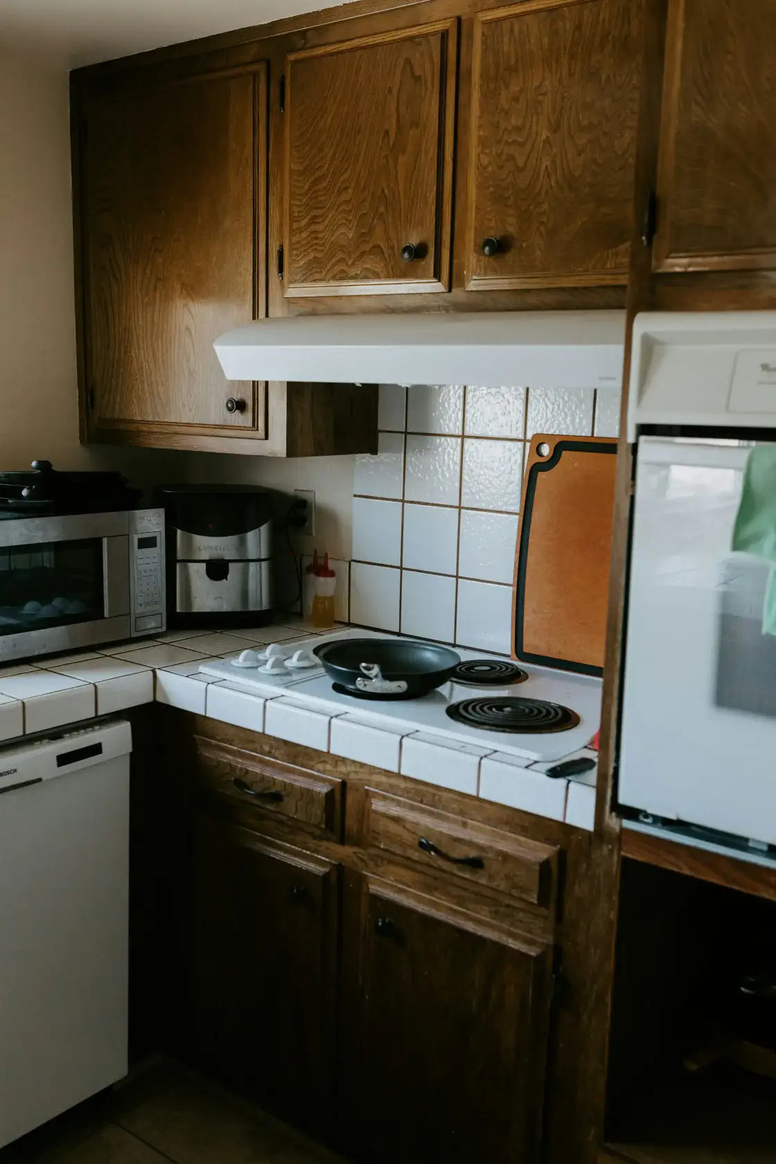 a kitchen with a stove, microwave, and dishwasher