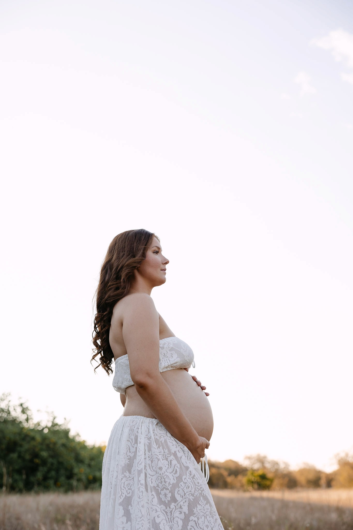 Pregnant women in grassy field in Mackay Queensland