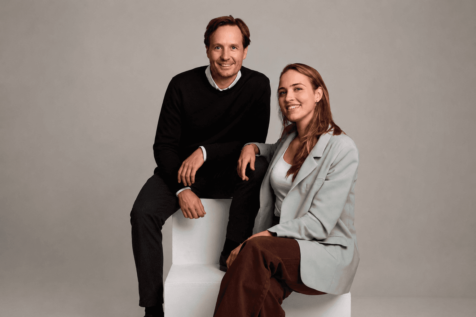 Blue team members smiling together in a studio portrait