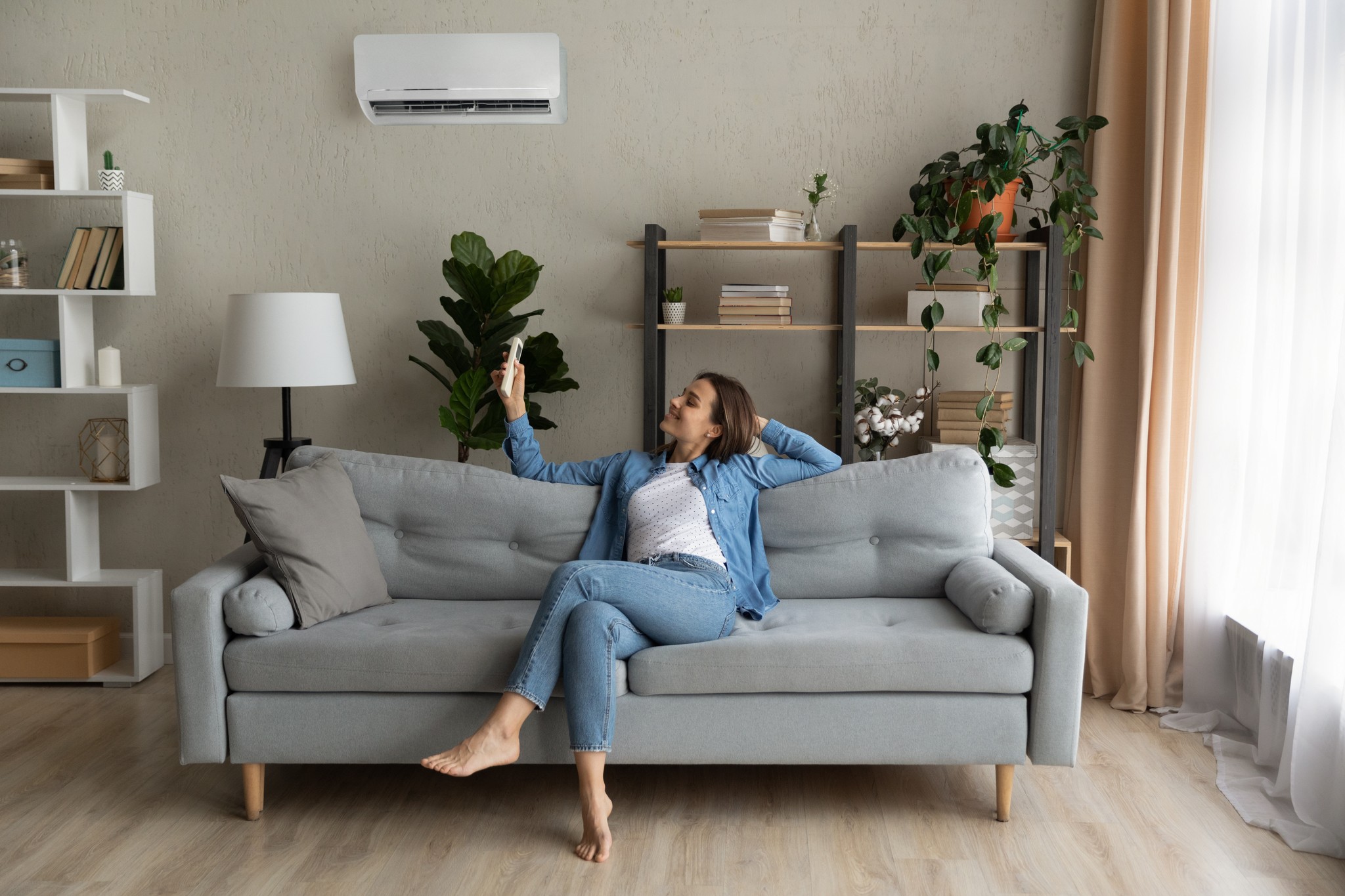 woman on sofa enjoying air conditioning