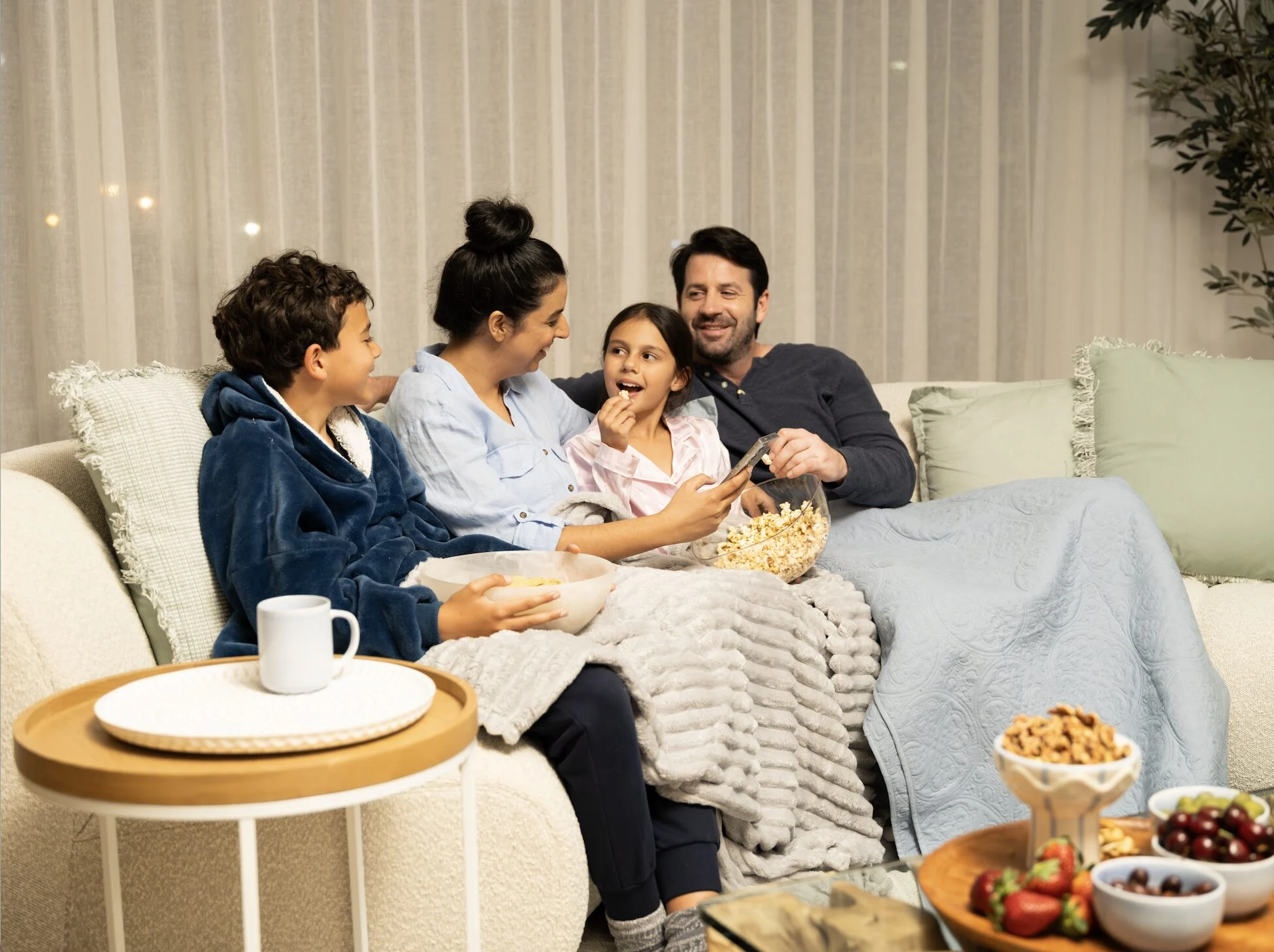 A happy family sitting comfortably on a couch