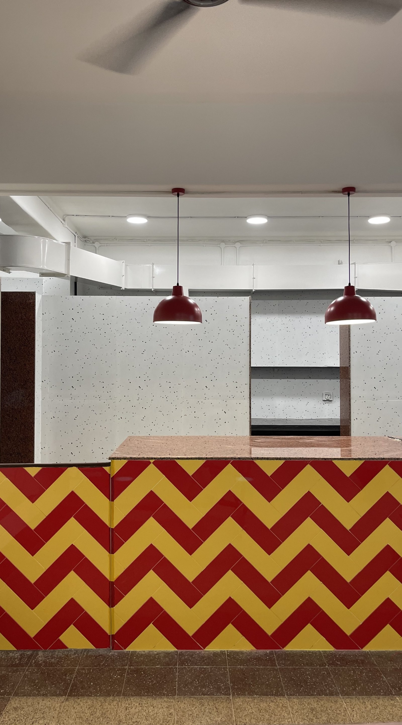 school dining area interior with bright coloured counter.