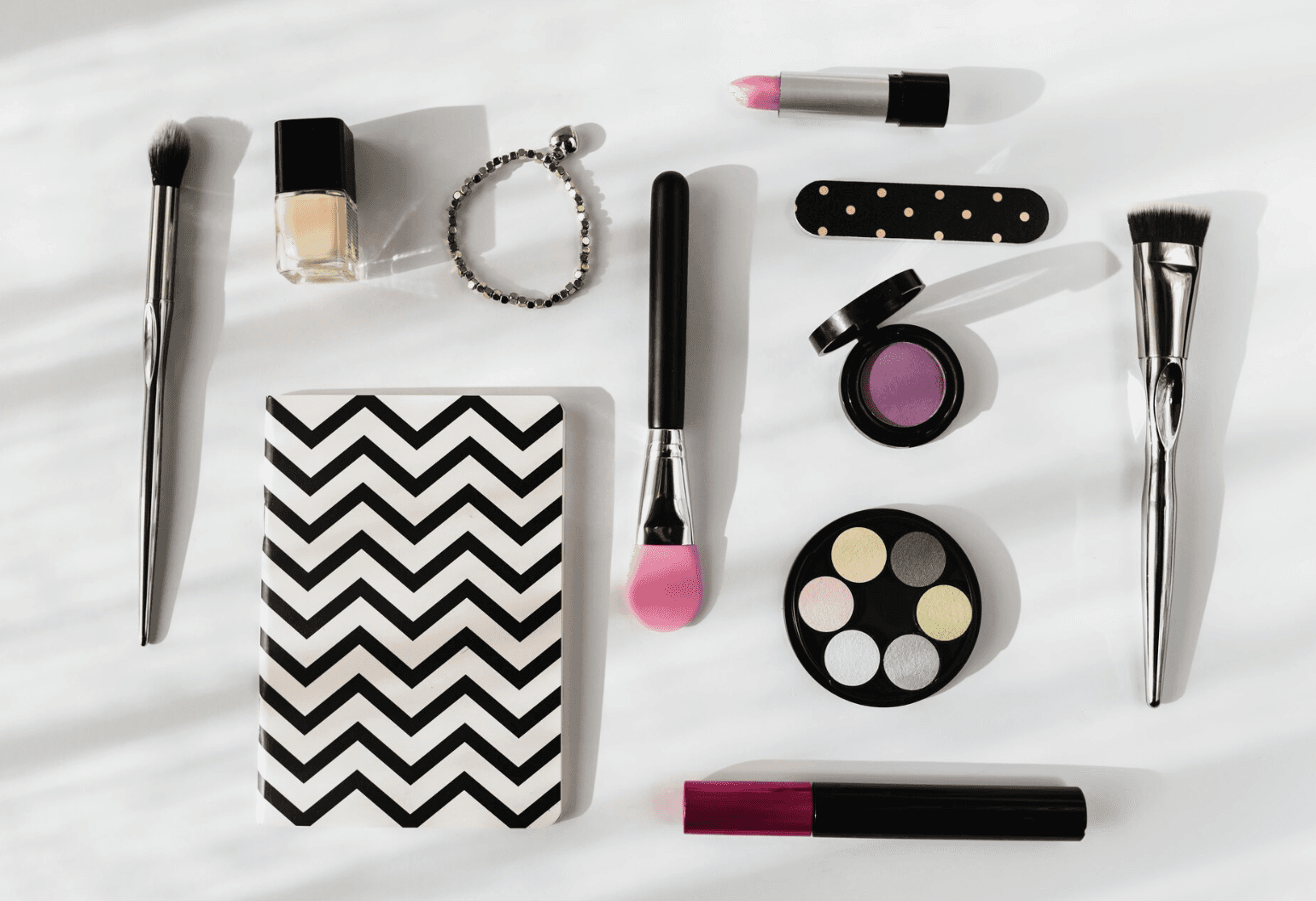 cosmetic makeup products and brushes flat lay