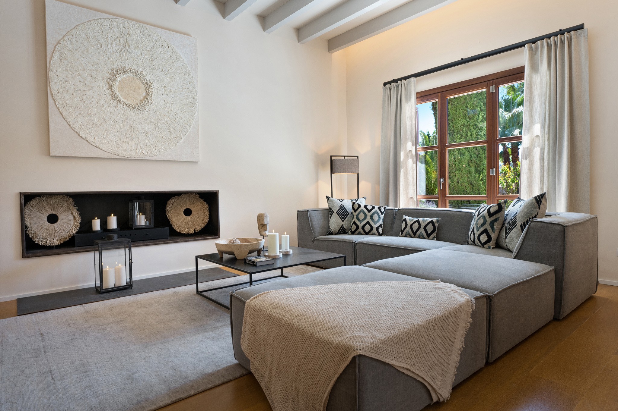 Interior Design Mallorca Wohnzimmer mit Kamin, natürlichen Materialien und stilvoller, zeitloser Einrichtung