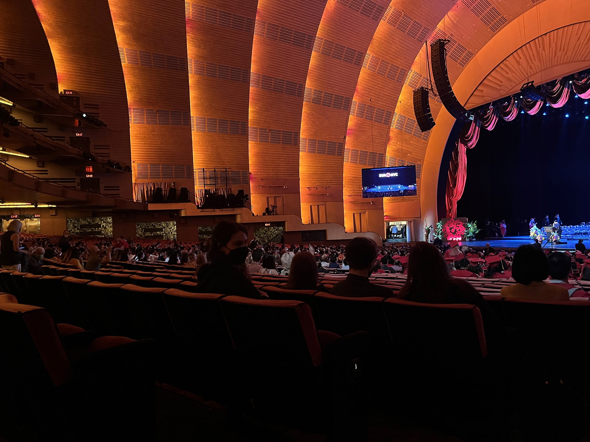 A photo of a theatre hall and the stage prepared for the SVA graduation ceremony.