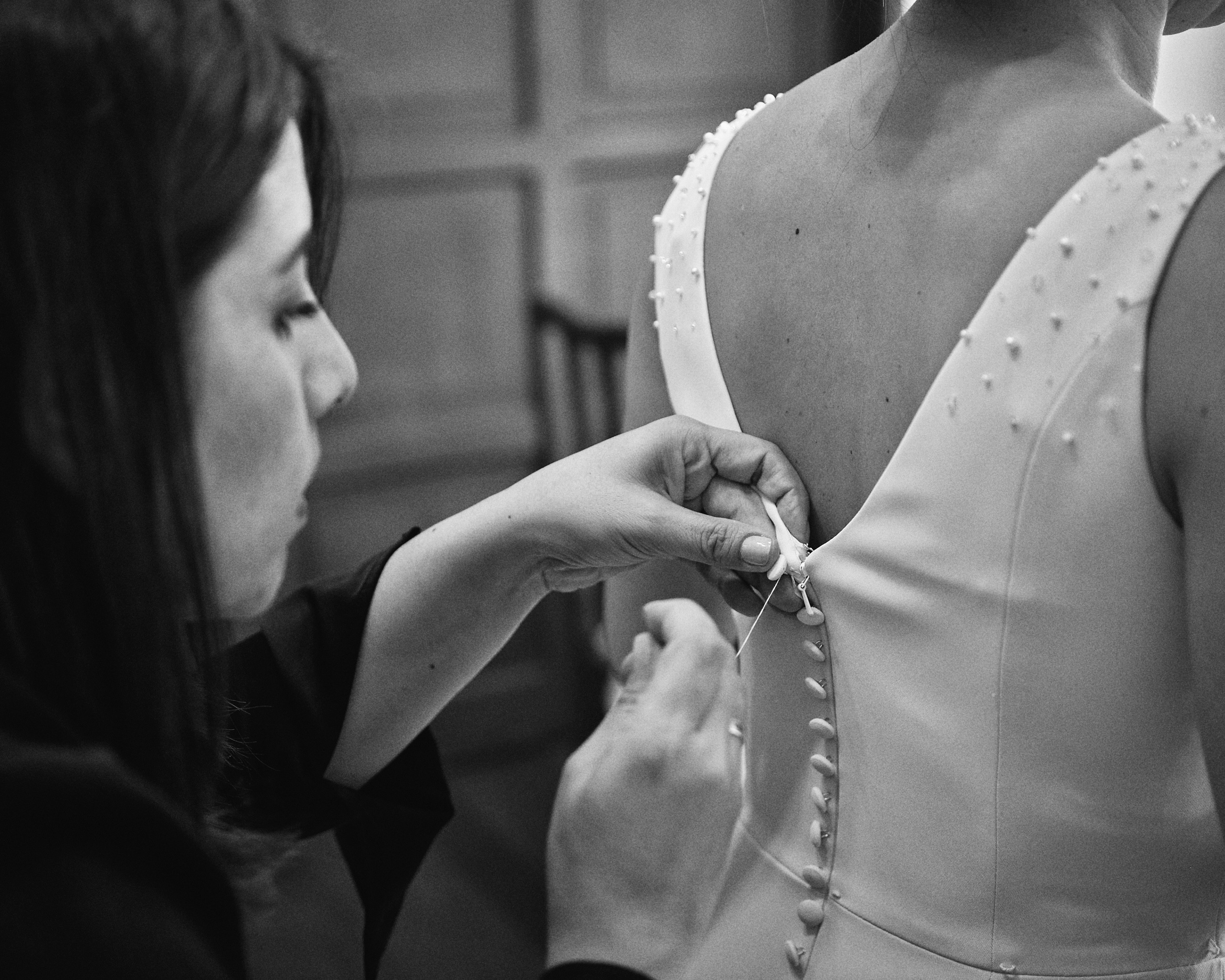 Bold editorial fashion portrait of model in houndstooth blazer with red tie and green shirt against bright turquoise background - Serif Creative Studio luxury fashion photography