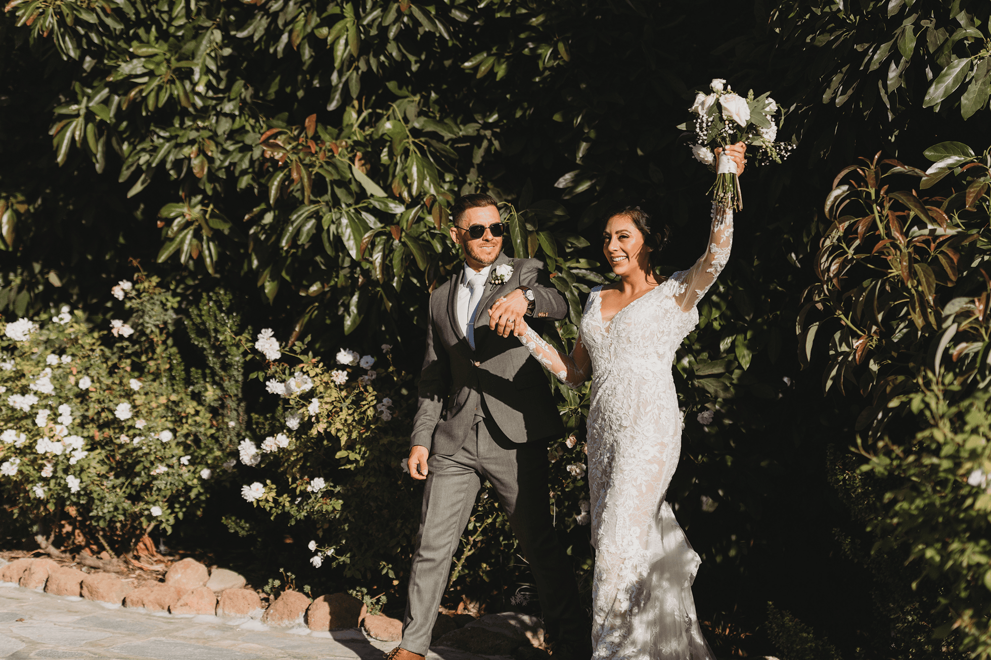 Flat lay wedding details with bouquet, rings, and sparkling bridal heels