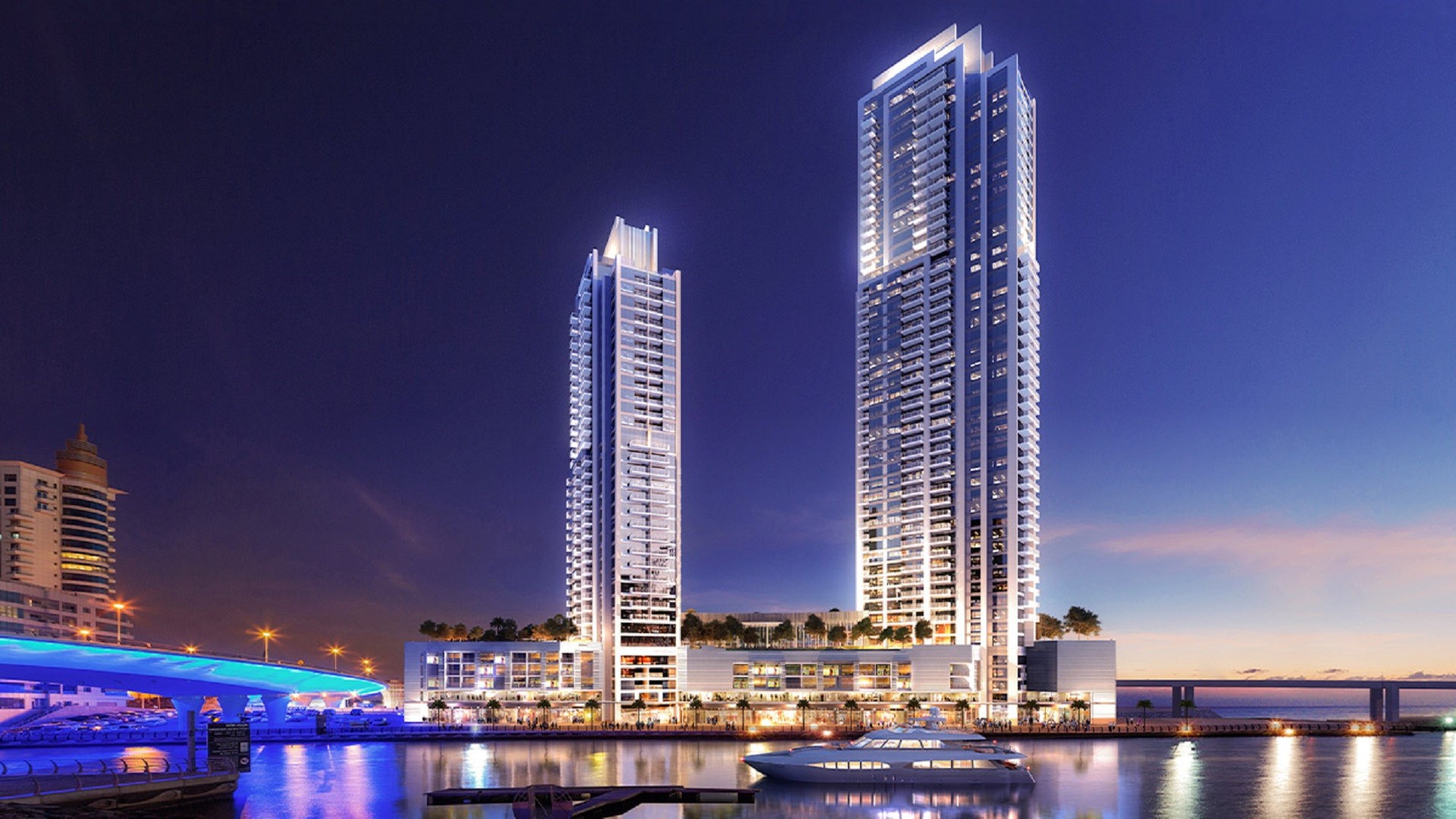 Two tall buildings stand beside a body of water, showcasing the 52 42 by Emaar development.