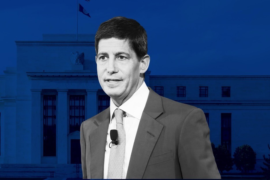 Trader analyzing stock market charts on multiple screens.