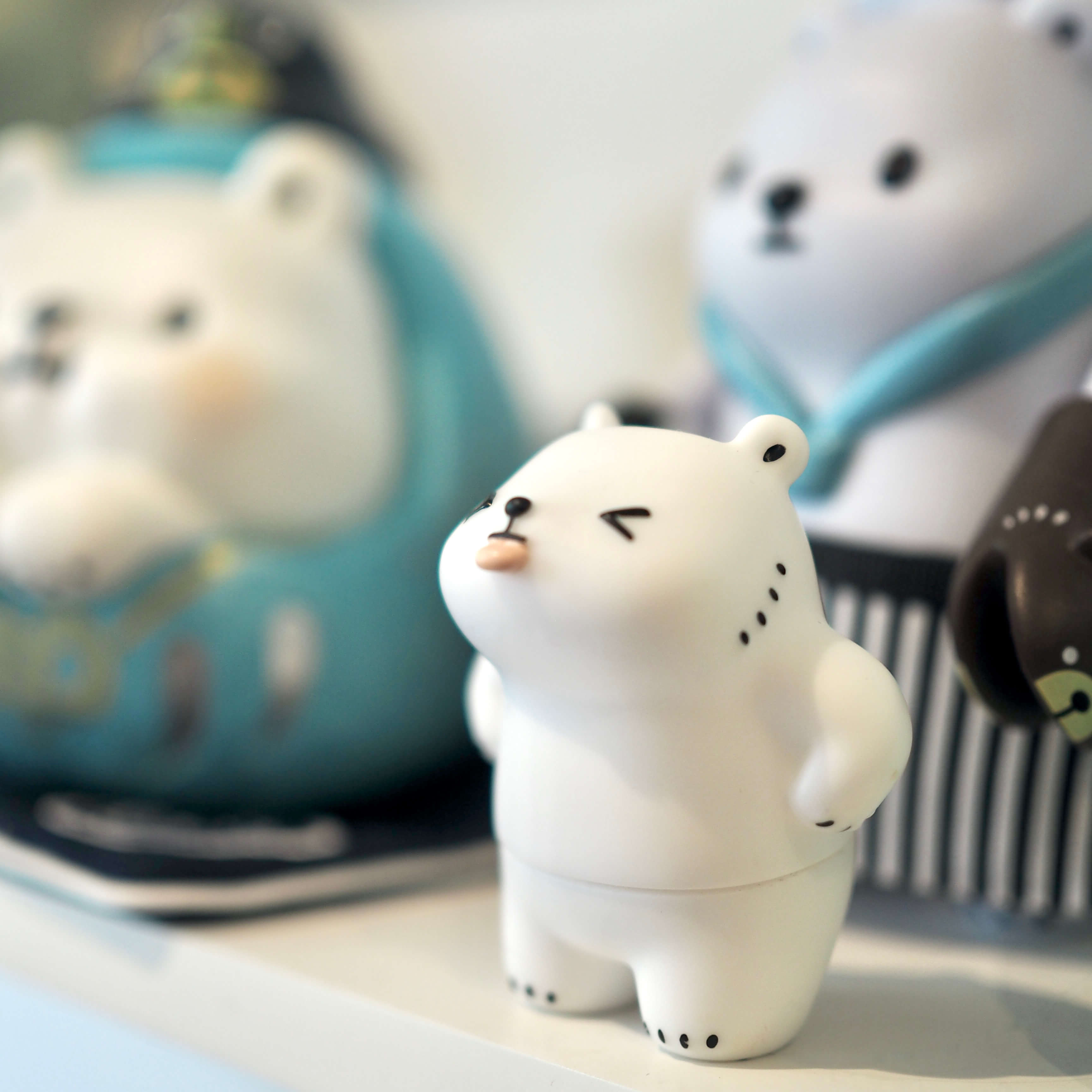 A small white bear figure sticking his tongue out. He's a sassy little guy.