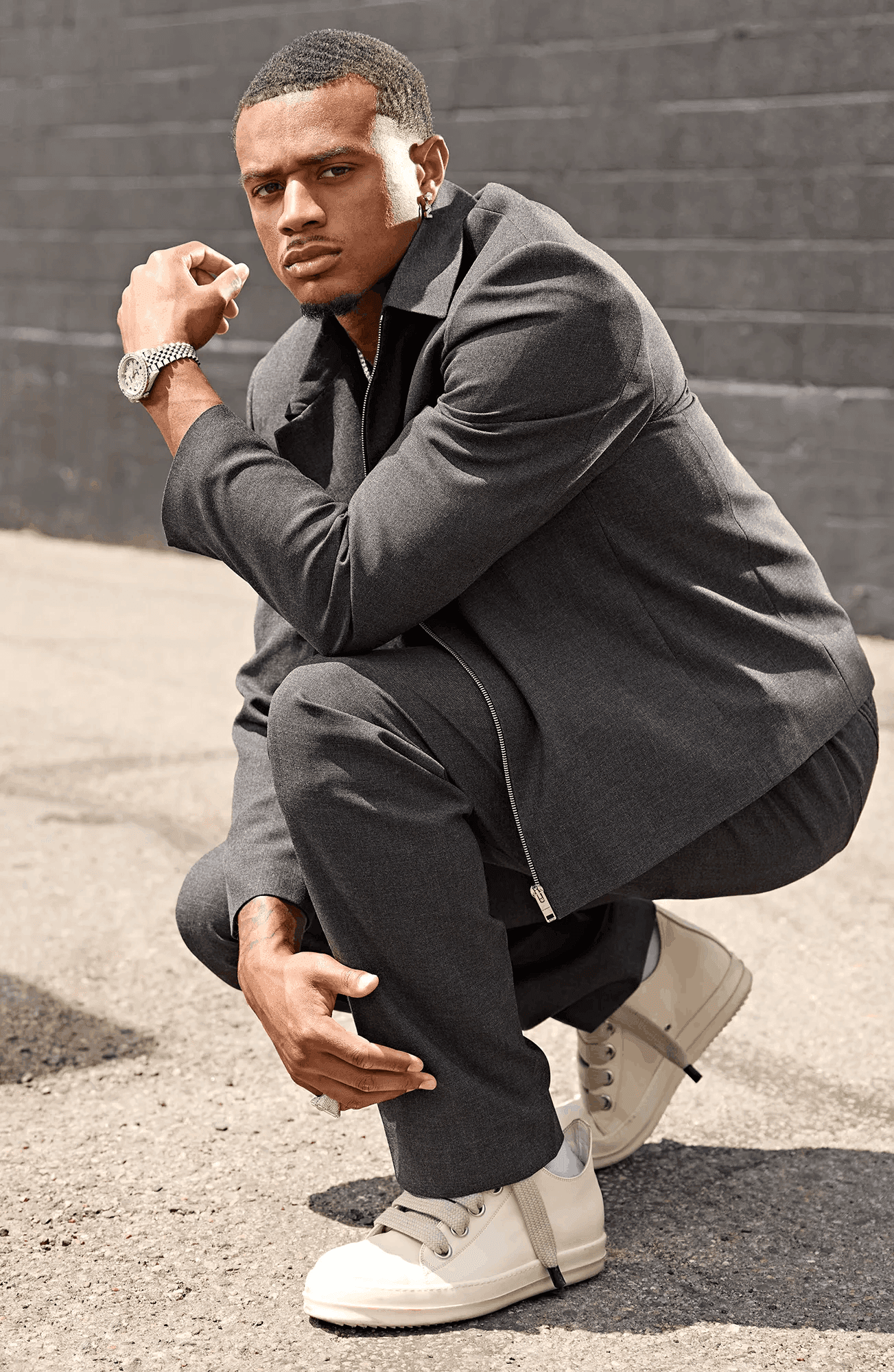 pat surtain poses in a suit in front of a brick wall