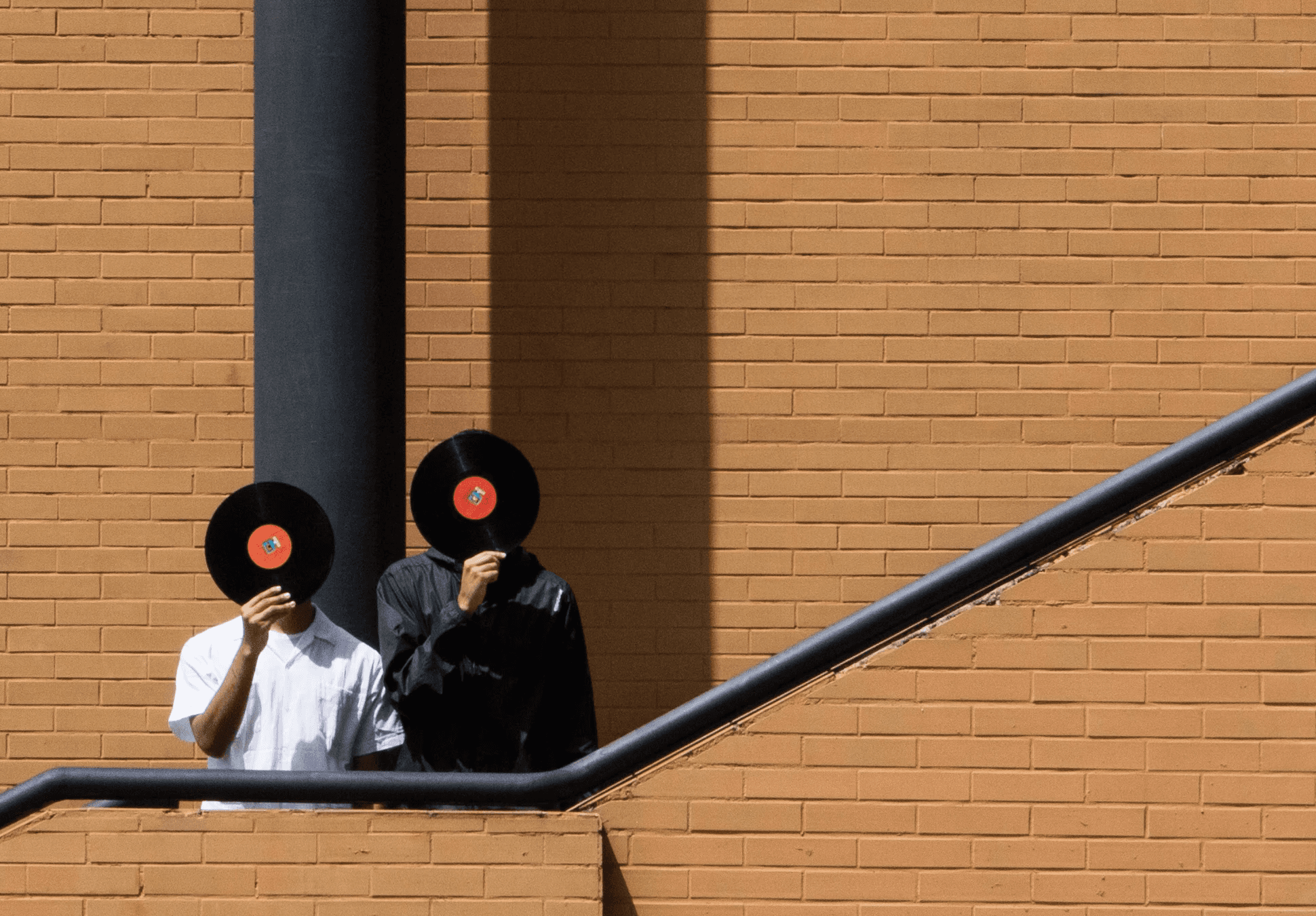 Collaborative work session overhead view of six people collaborating at a rustic wooden table with coffee, papers, and a laptop