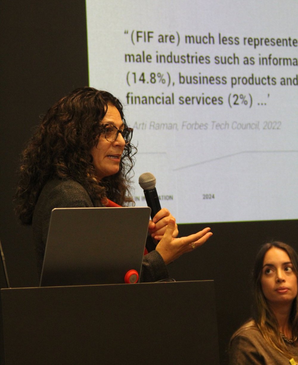 Speaker holding a microphone