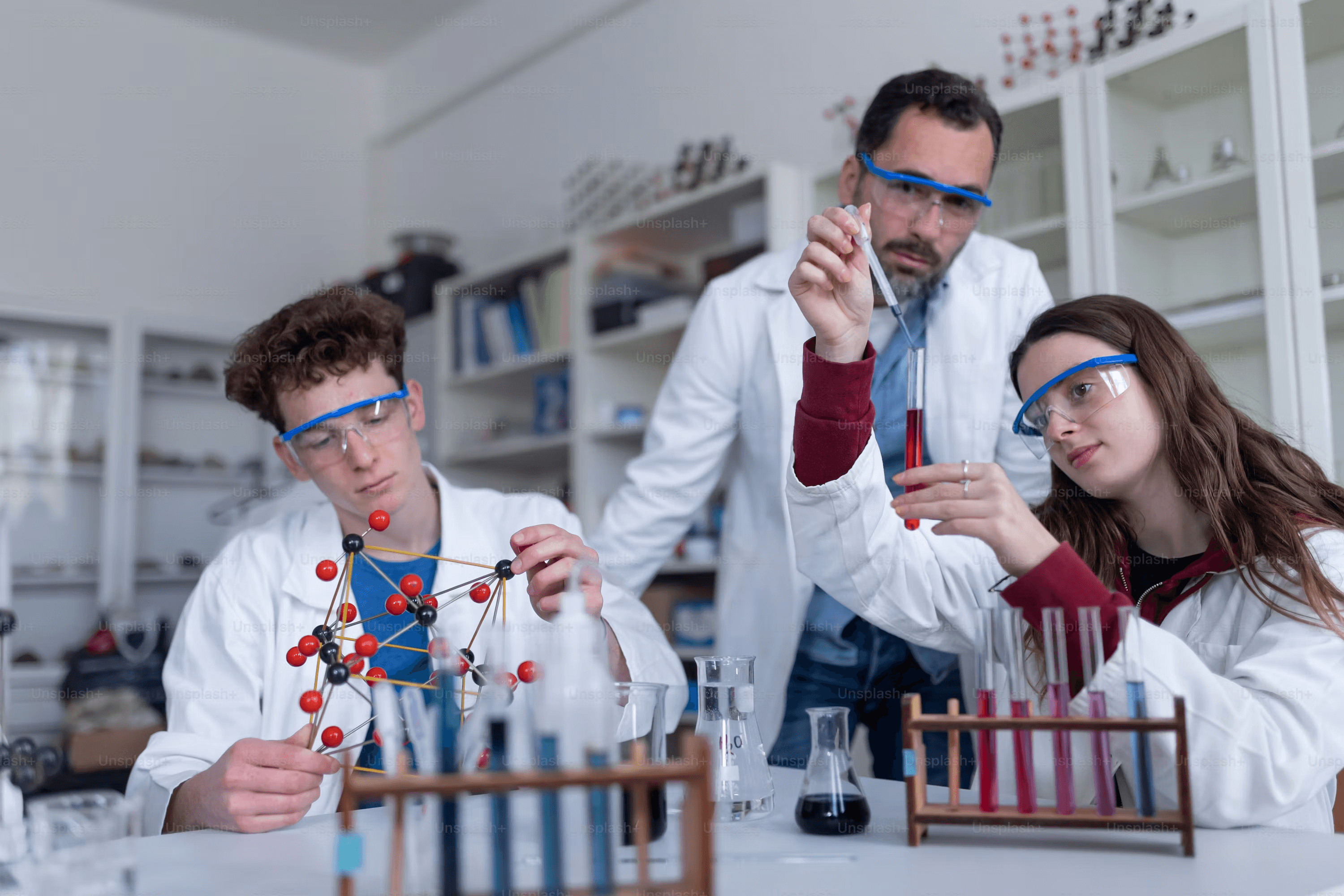 High school student conducting chemical engineering research under PhD mentor guidance in a university laboratory setting