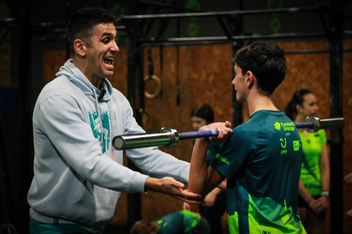 woman in black and white checkered long sleeve shirt sitting beside man in green crew neck