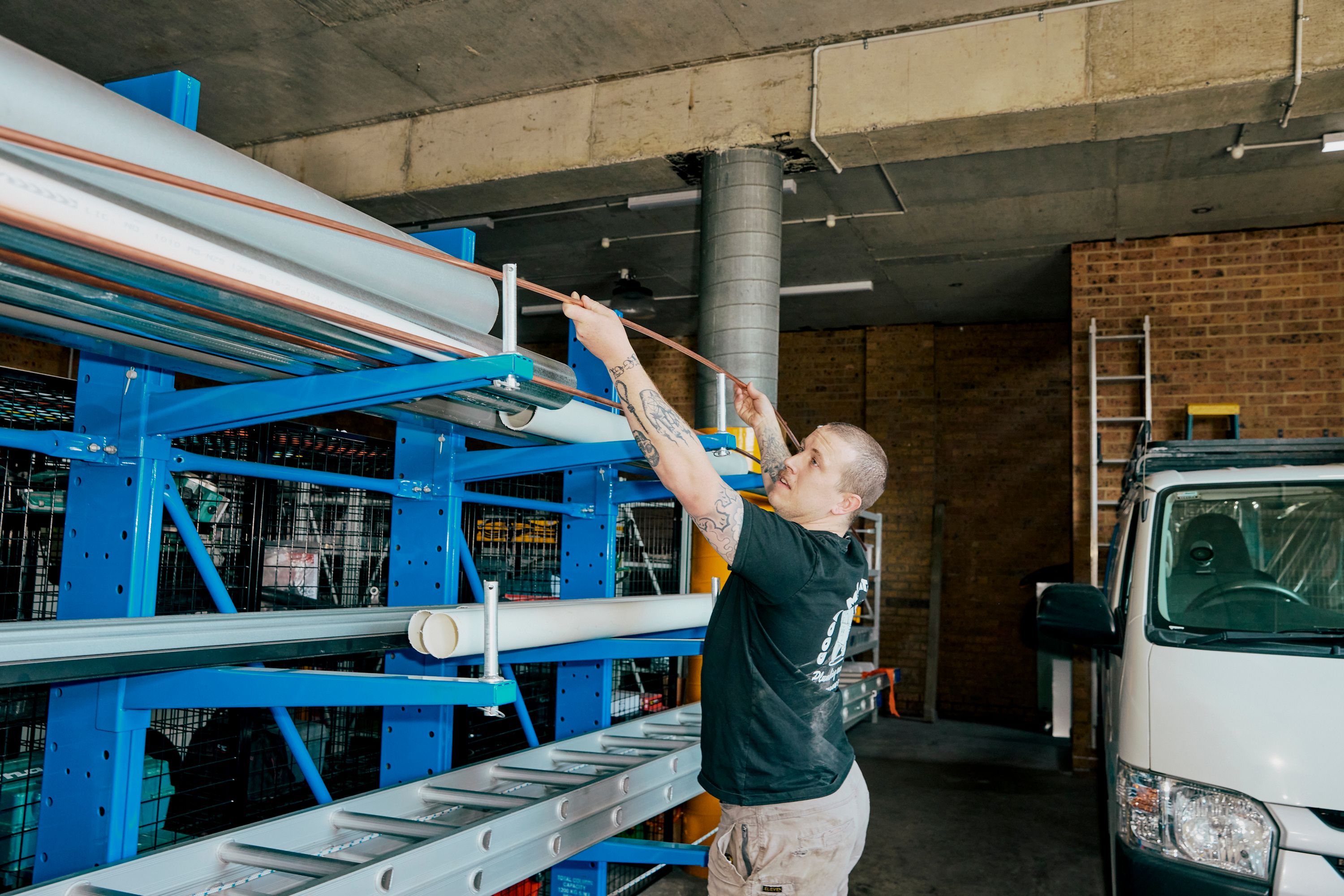 Good Maintenance Tecnician collecting pipe from storage shelves in storeroom