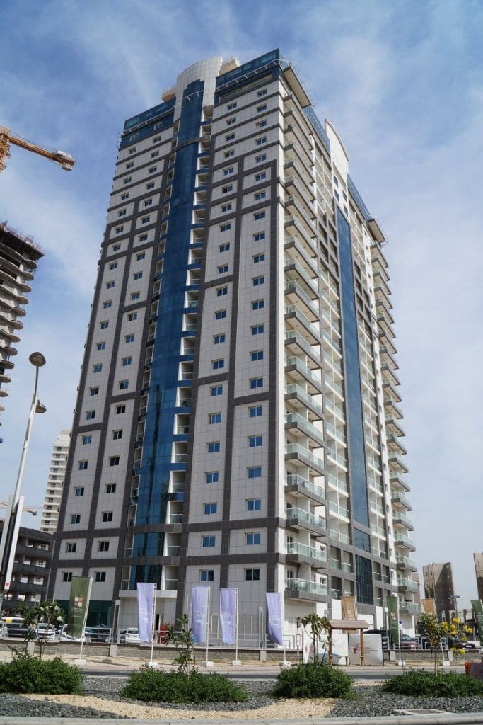 Up-close facade of Red Residence building, featuring luxury residential units managed by our estate team.