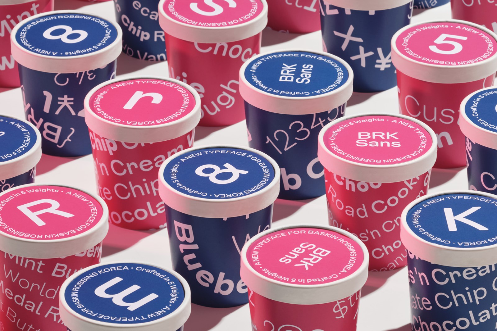 A close-up of various colored poker chips, stacked in red, blue, and pink, with different denominations visible.