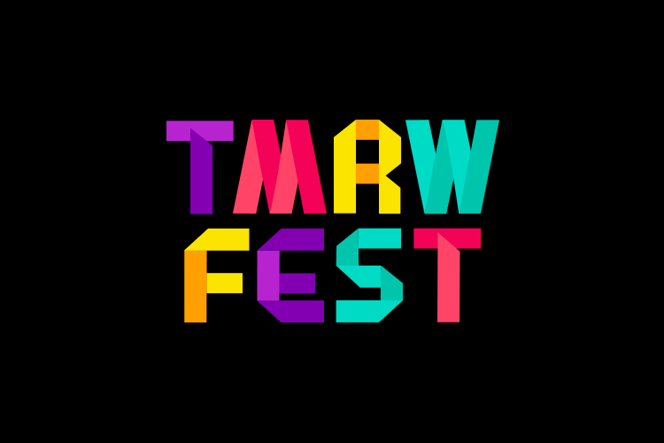 The letters "TMRWFEST" are displayed in a pixelated, multicolored font against a black background. The letters are arranged vertically, with each letter in a distinct color: purple, red, yellow, teal, orange, and pink. The letters have a slightly three-dimensional appearance.