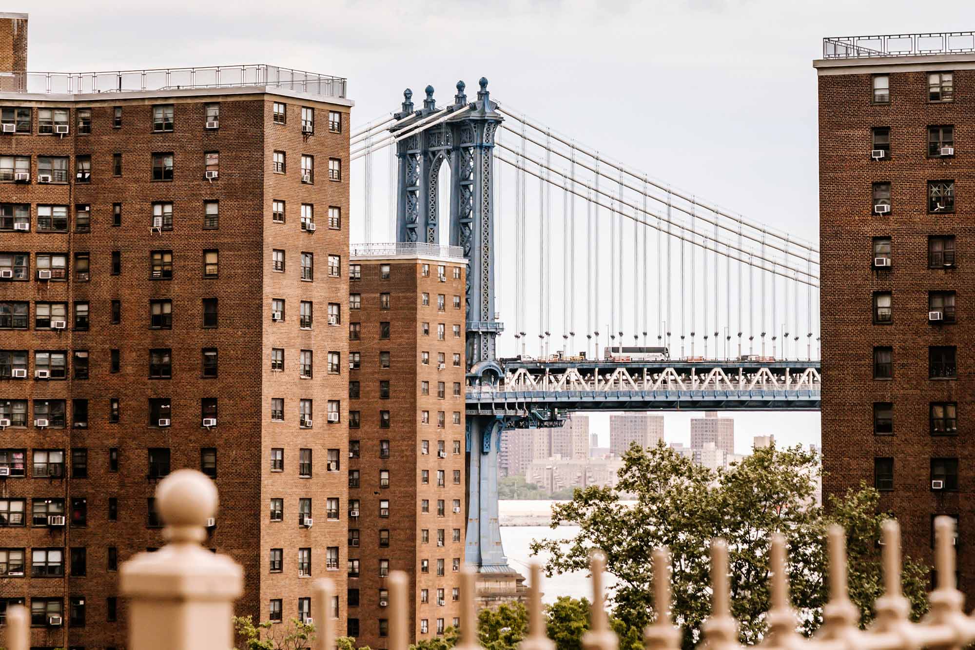 Brooklyn Bridge framed by brick buildings