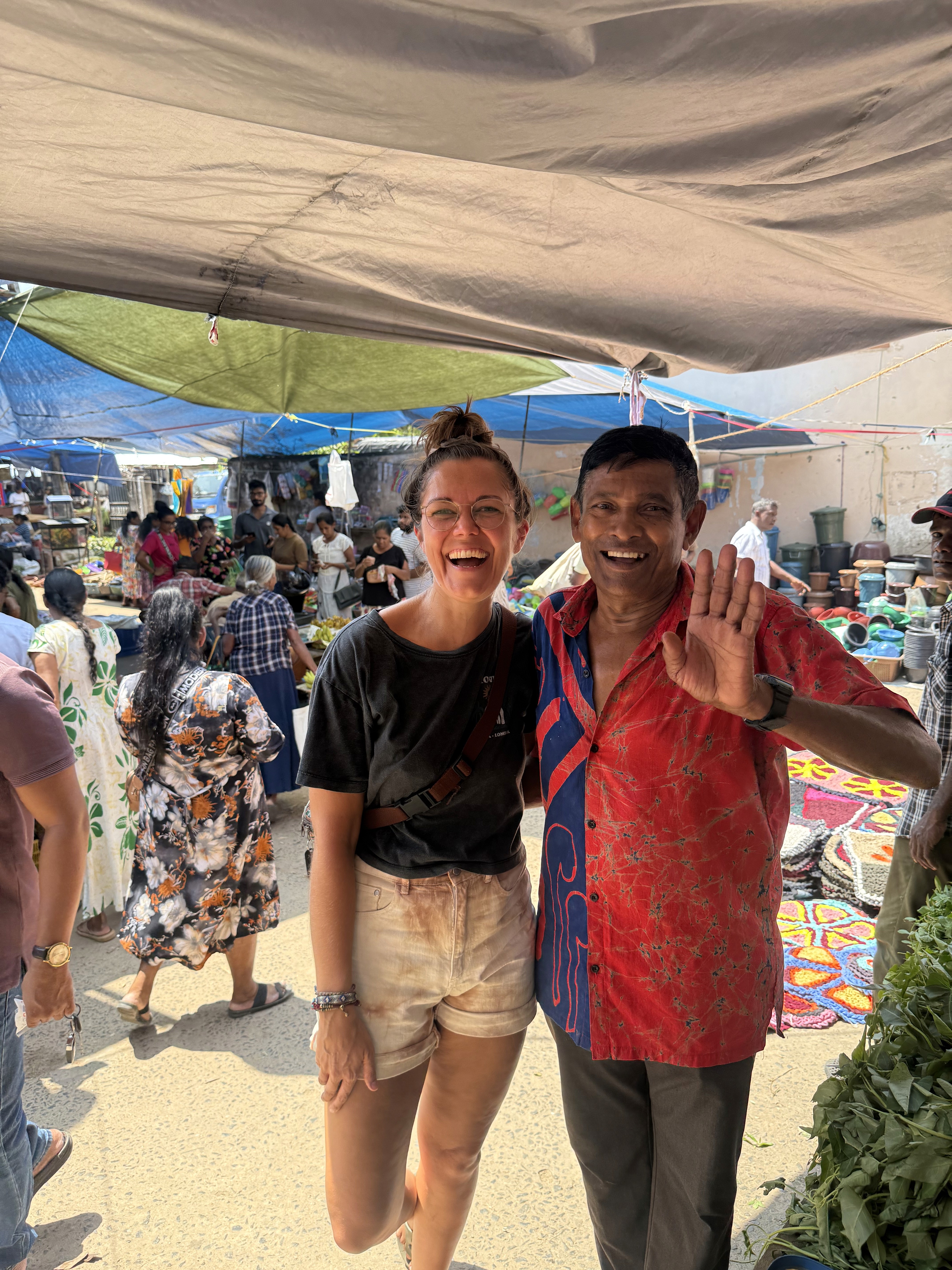 Eva visiting a local market and connecting with community members during her travels.