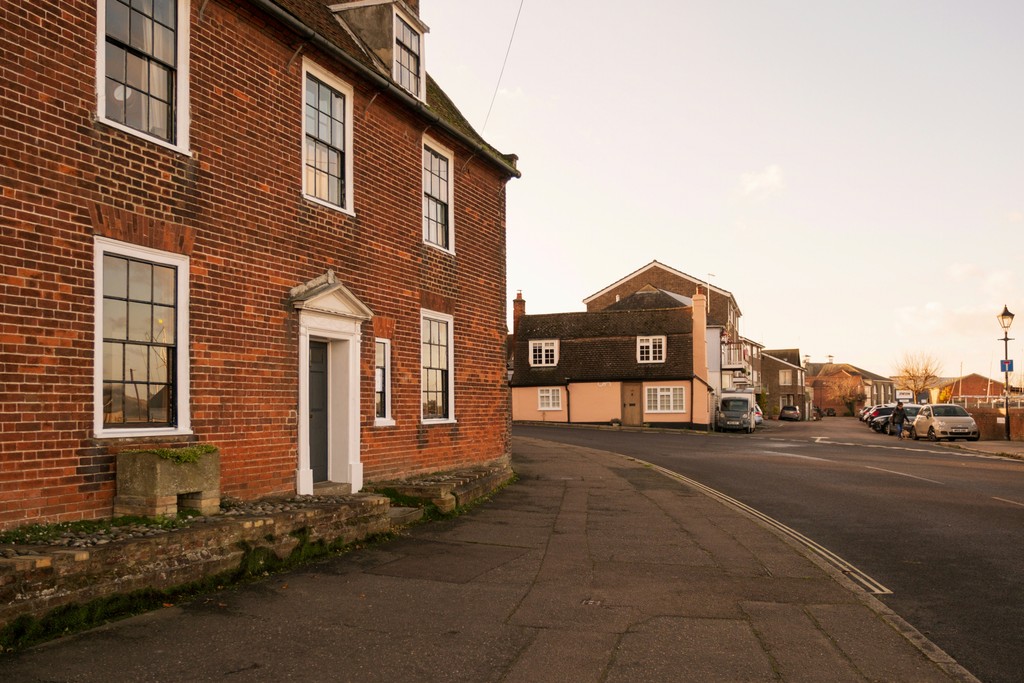 A brick building with a white door and windows